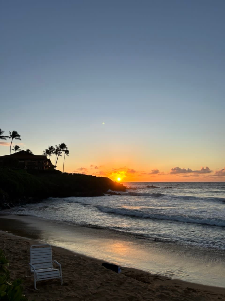 A chair placed on the sand at the beach