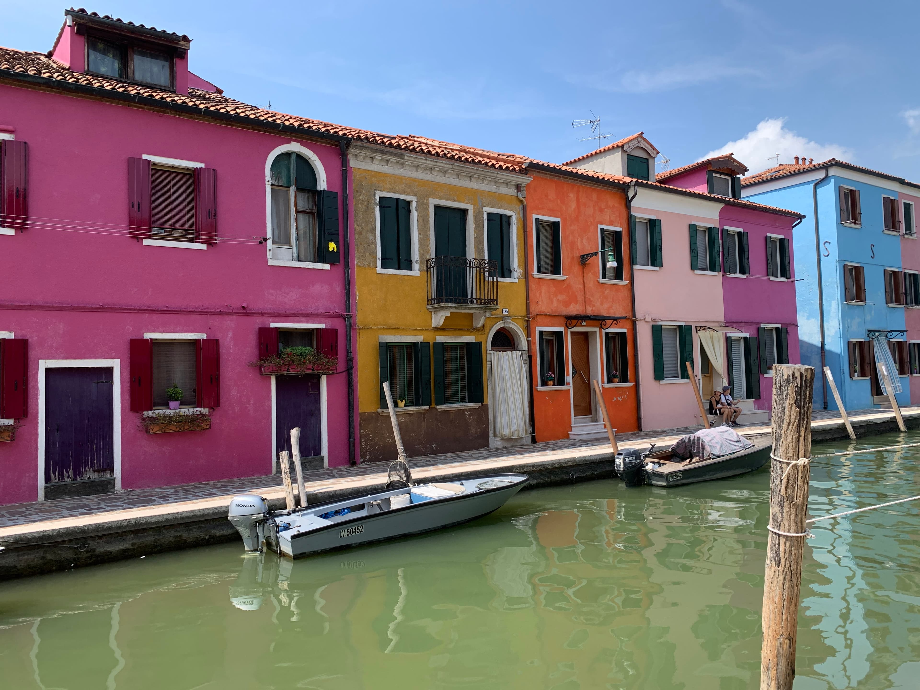 A photo of colorful row houses lining a canal