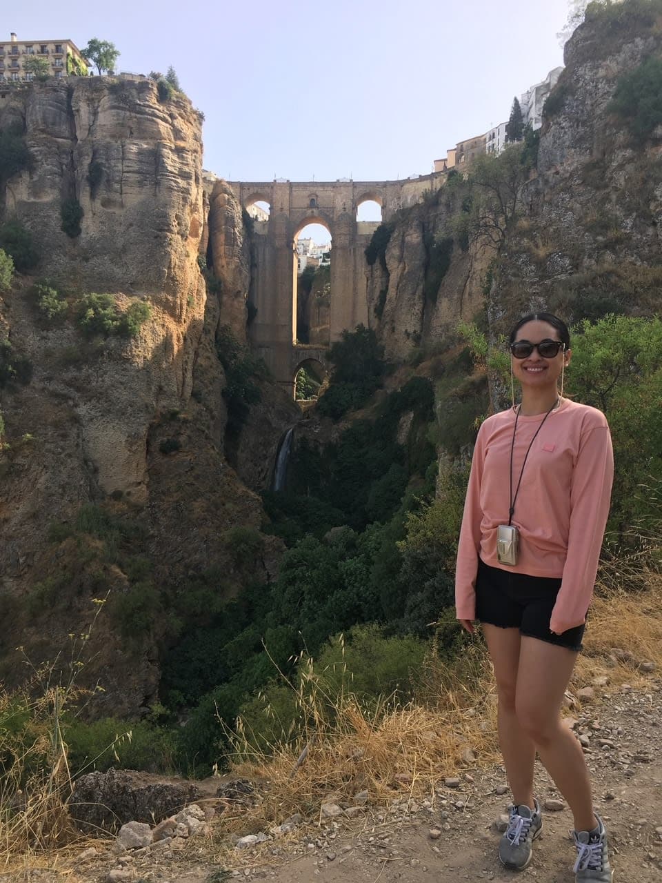 Picture of Neomi on a hike with ruins in the distance