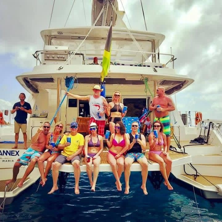 Travel advisor Lisa with a group of people sitting by a pool on a cruise during the day