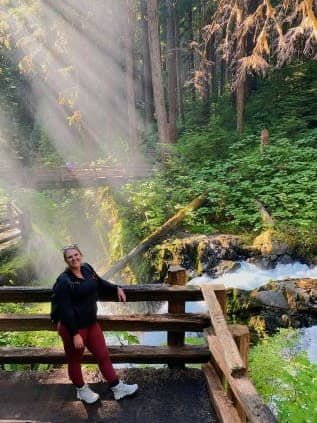 Posing for a photo on the deck with river flowing down