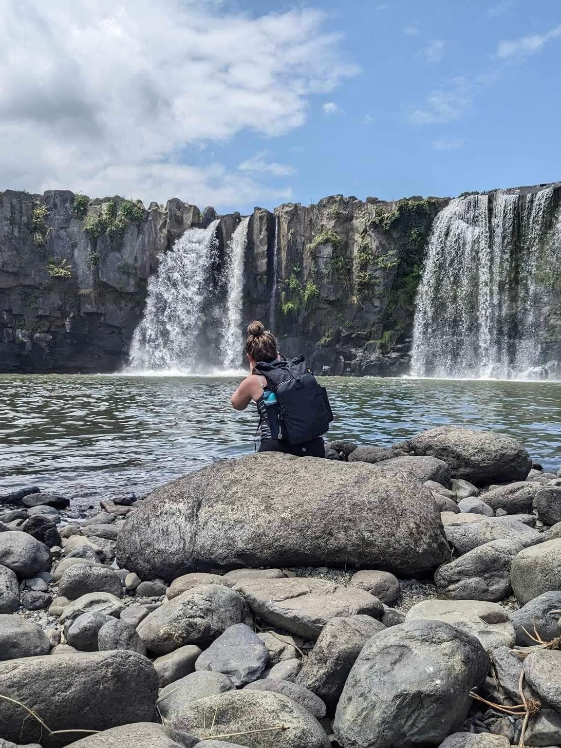 Sitting on the rocks and enjoying the beautiful view of the waterfall