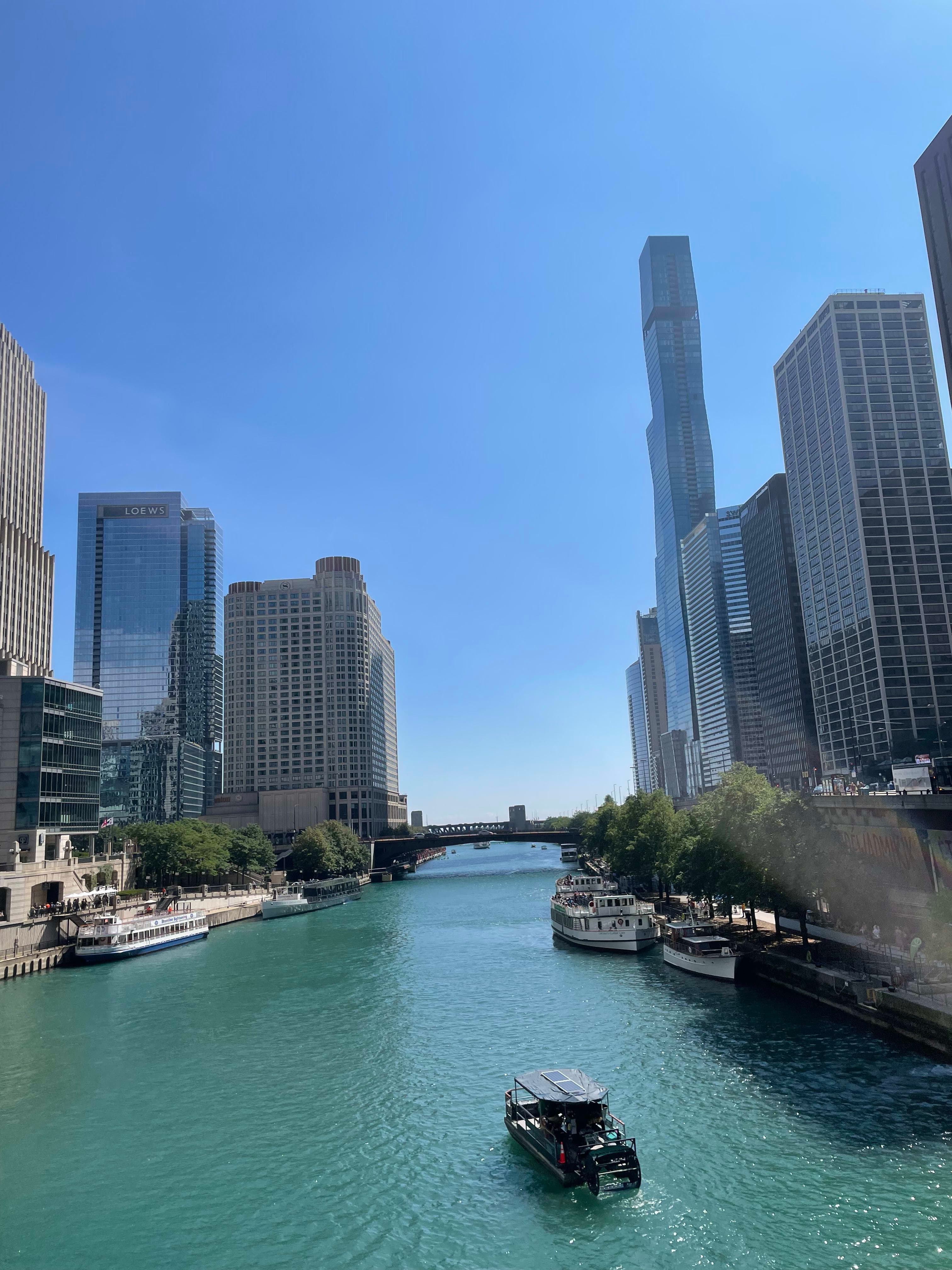 A ship sailing in the Chicago River on a sunny day