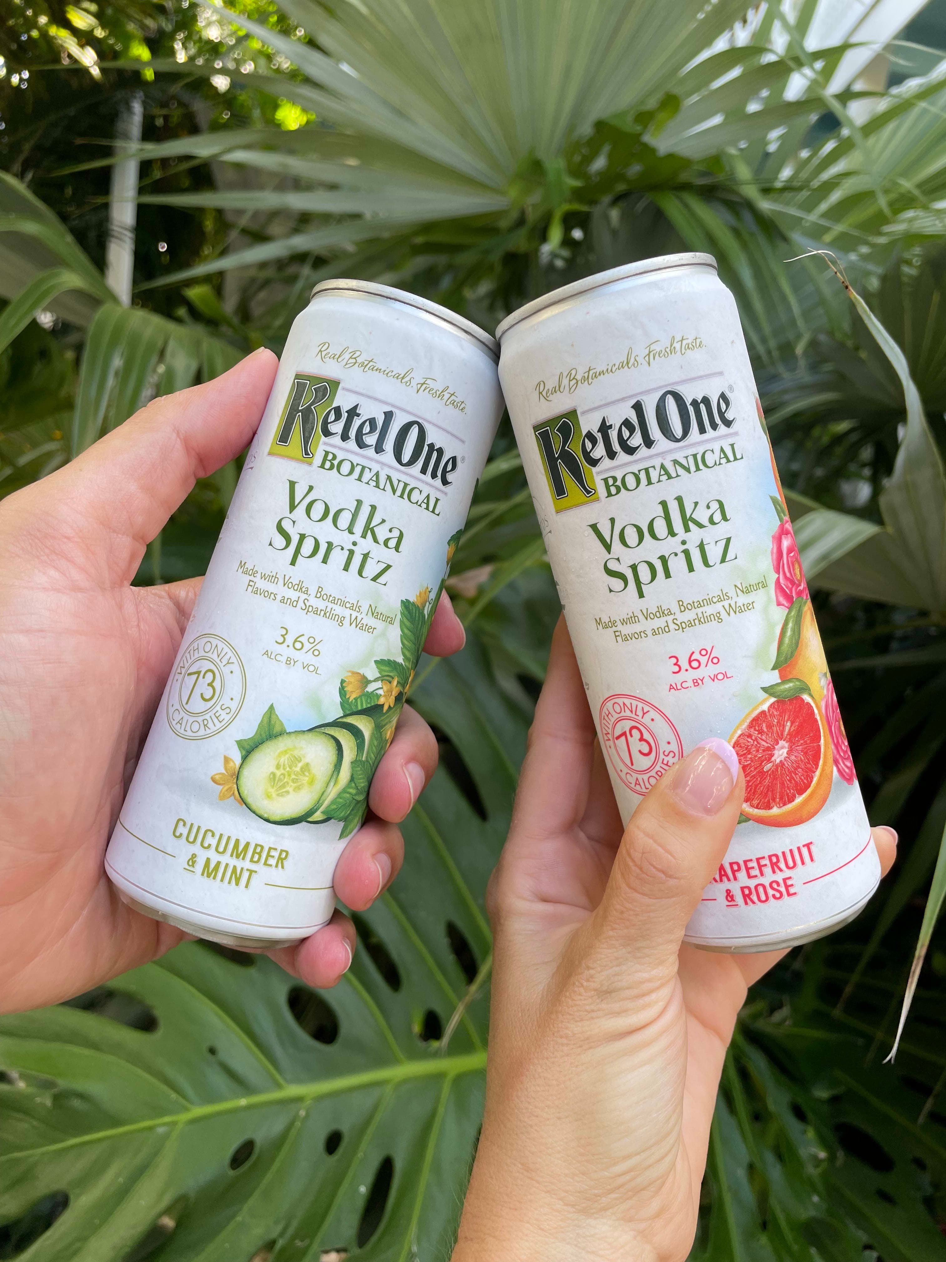 Photo of alcoholic beverages in a can with lush greenery in the background