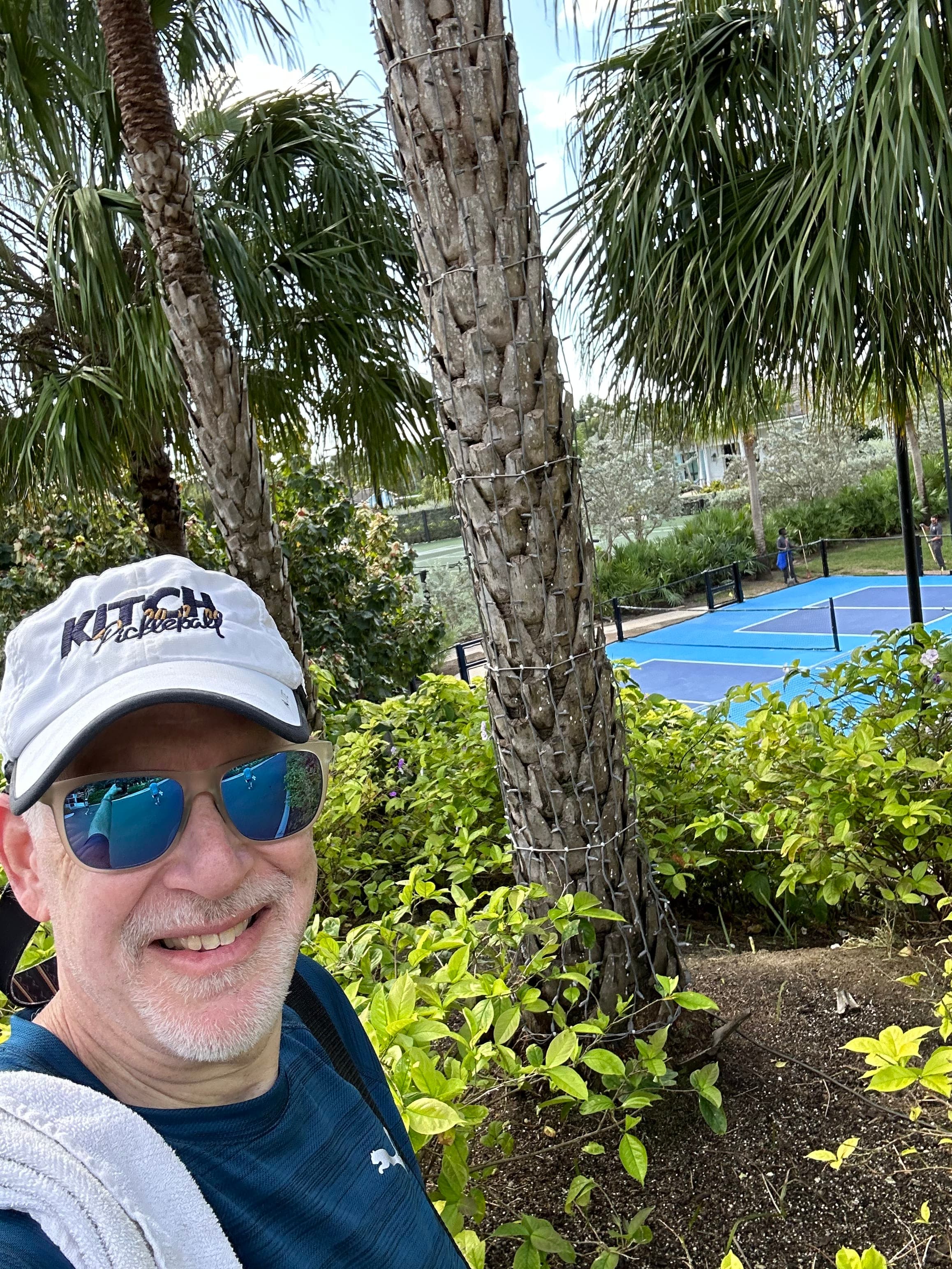 Picture of Jayson with tennis court and foliage in view