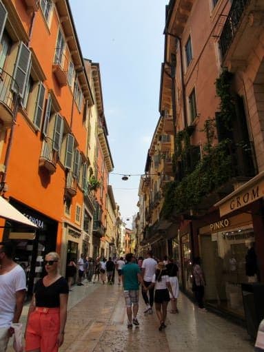 People walking on a street with shops on both sides