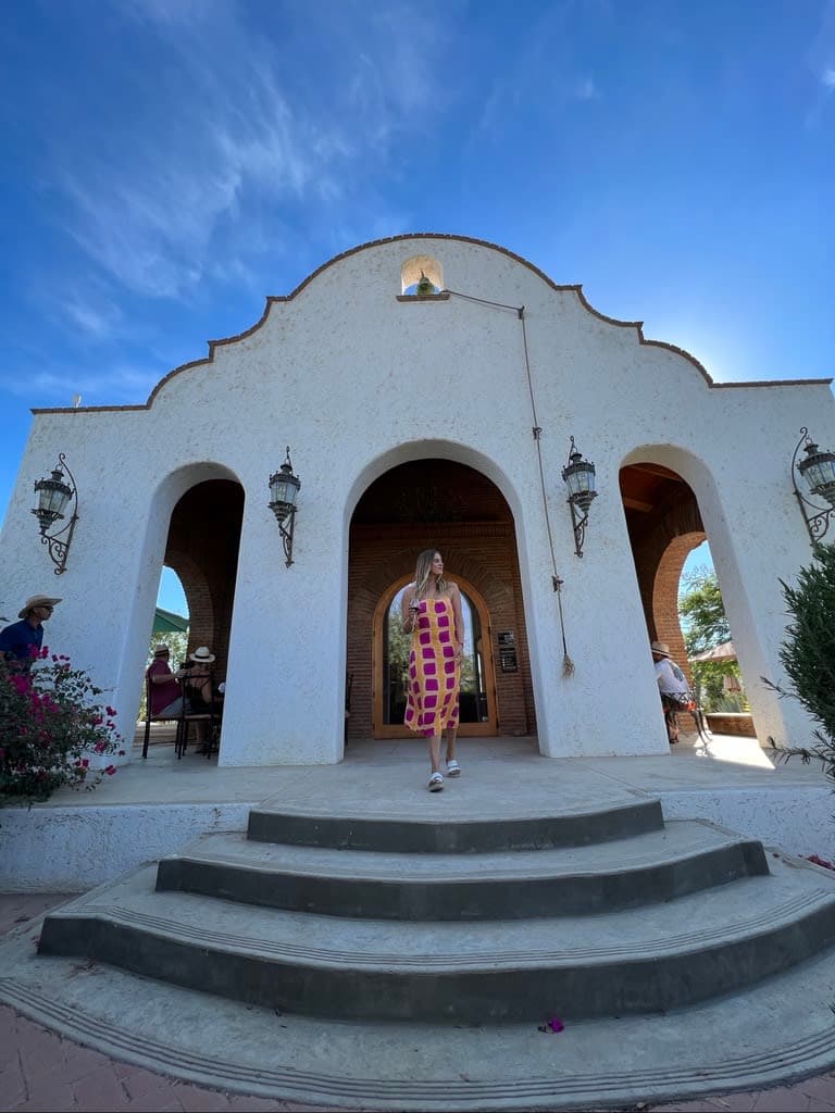 Picture of Chelsea at Vinicola Adobe Guadalupe, a white clay building with stairs leading to the entrance
