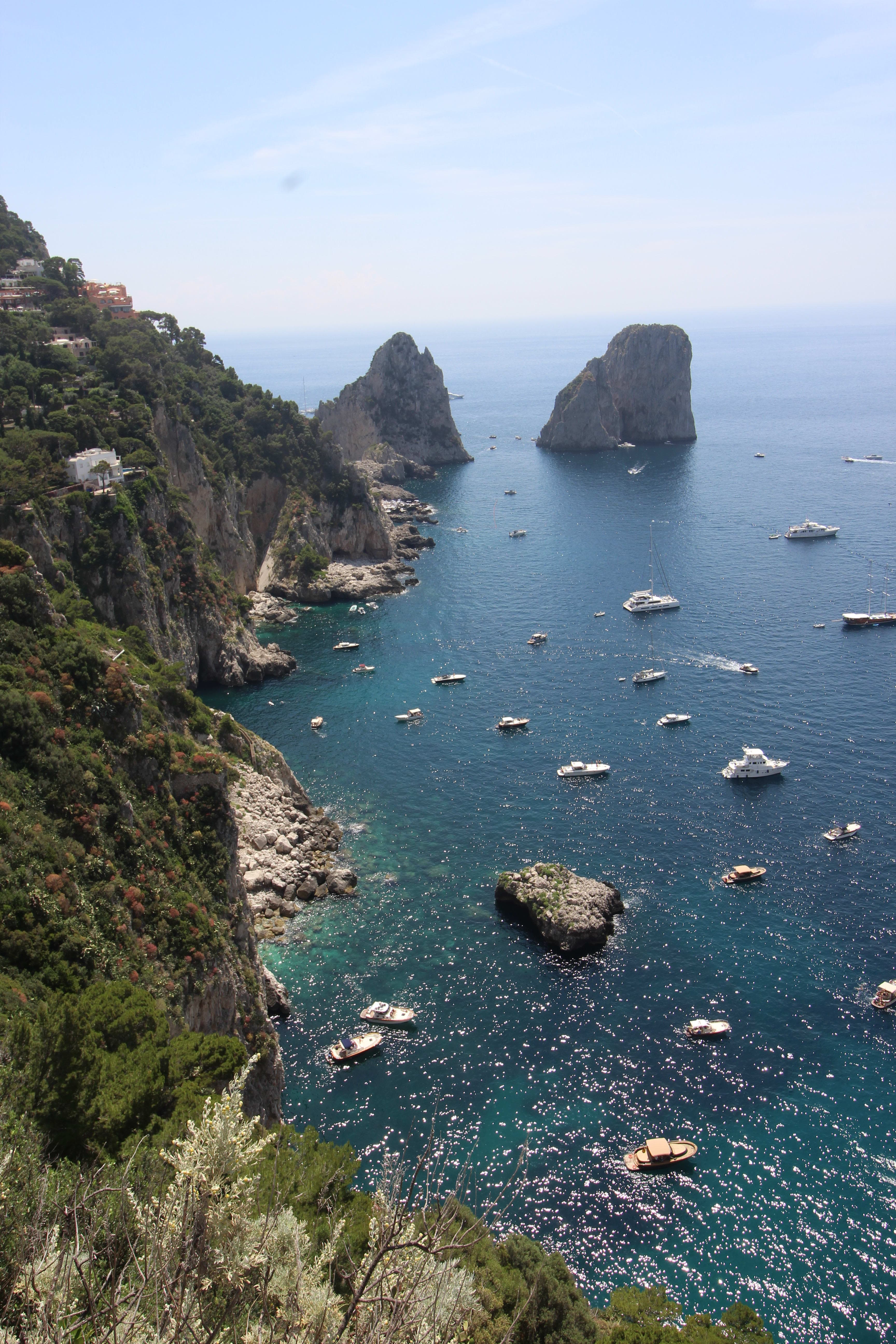 Blue water of the sea with sailing boats and an islands on the side