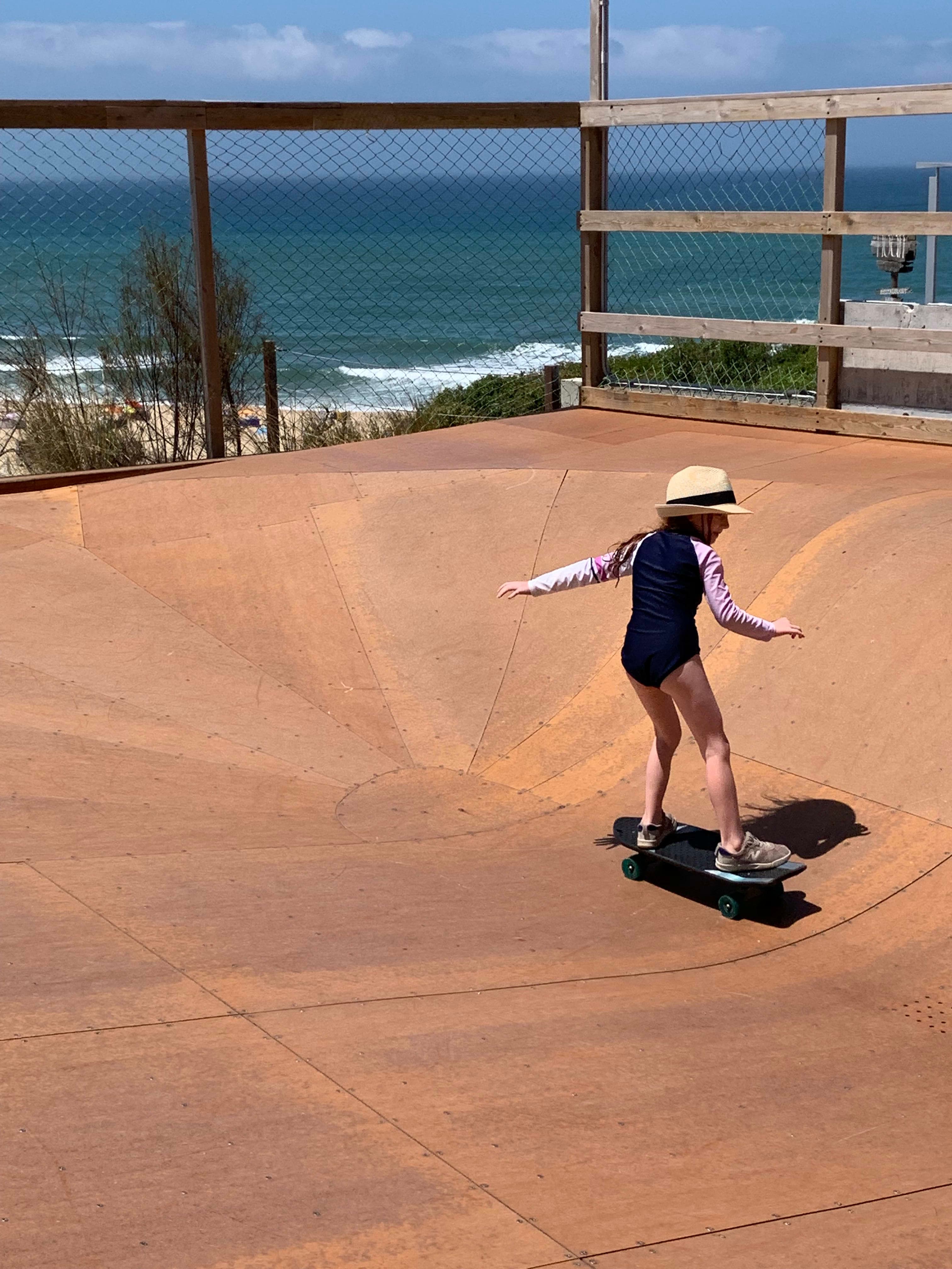 A girl skateboarding in the rink