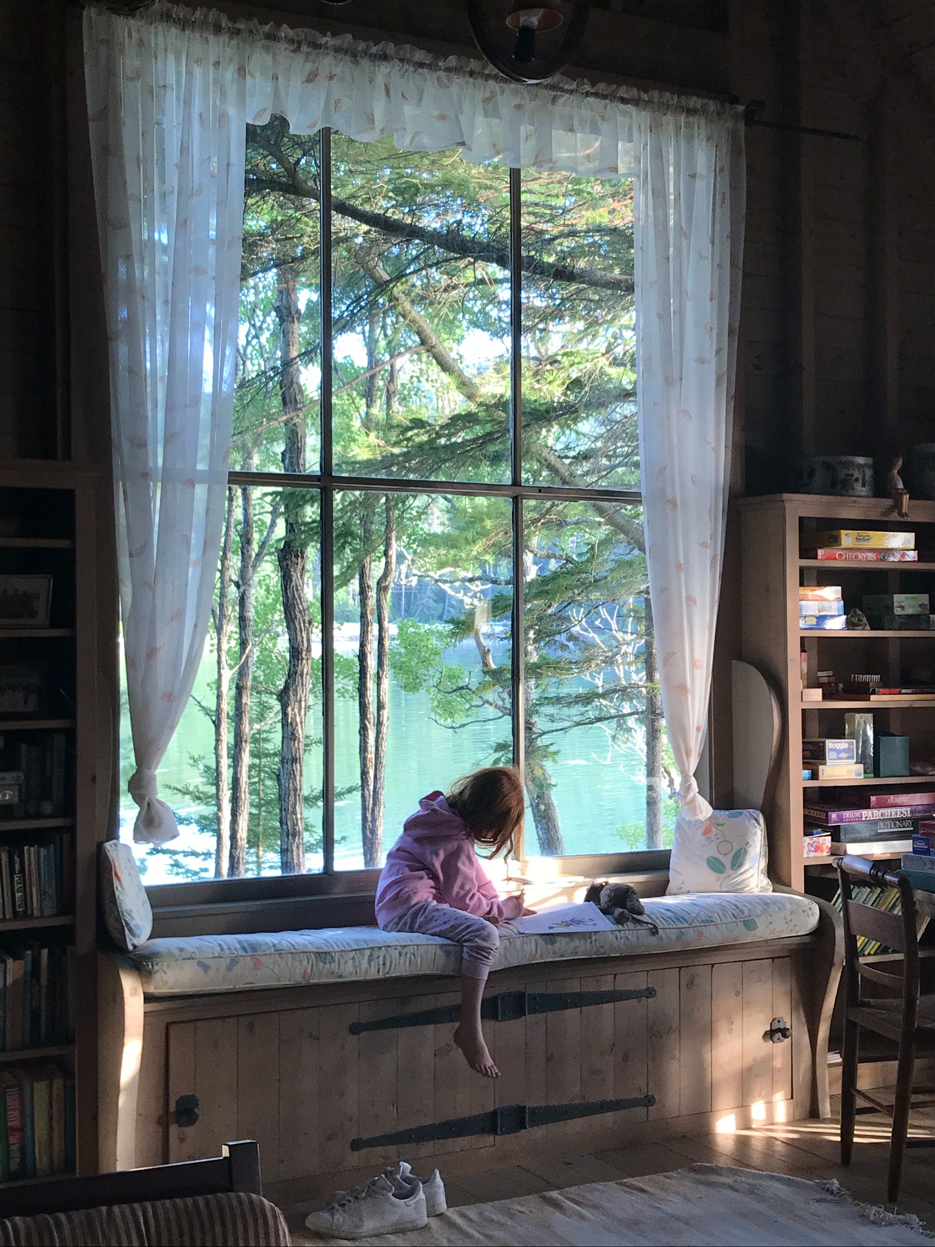 A child sitting on a bay window