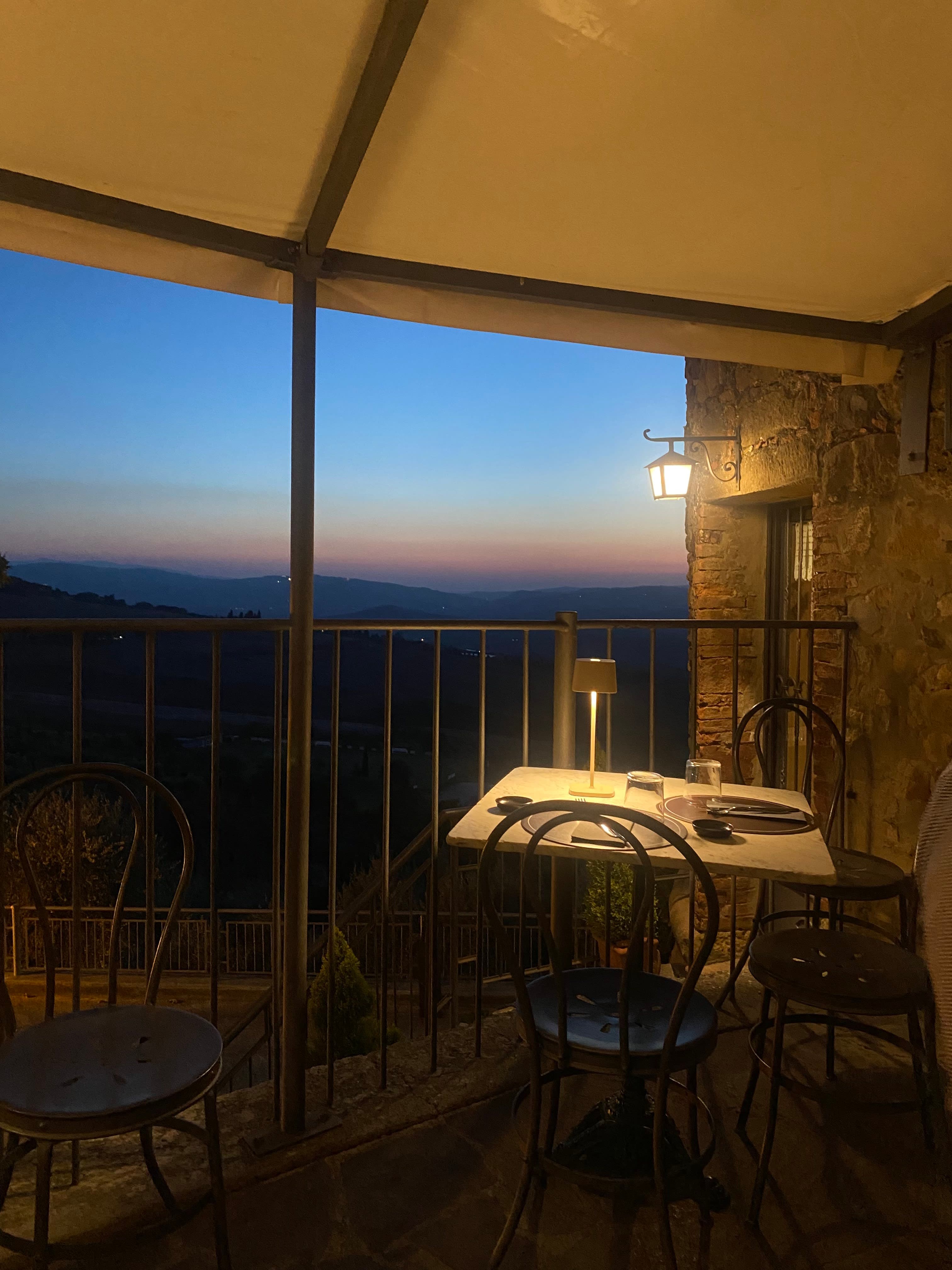 Sitting area on a balcony overlooking beautiful view of Italy