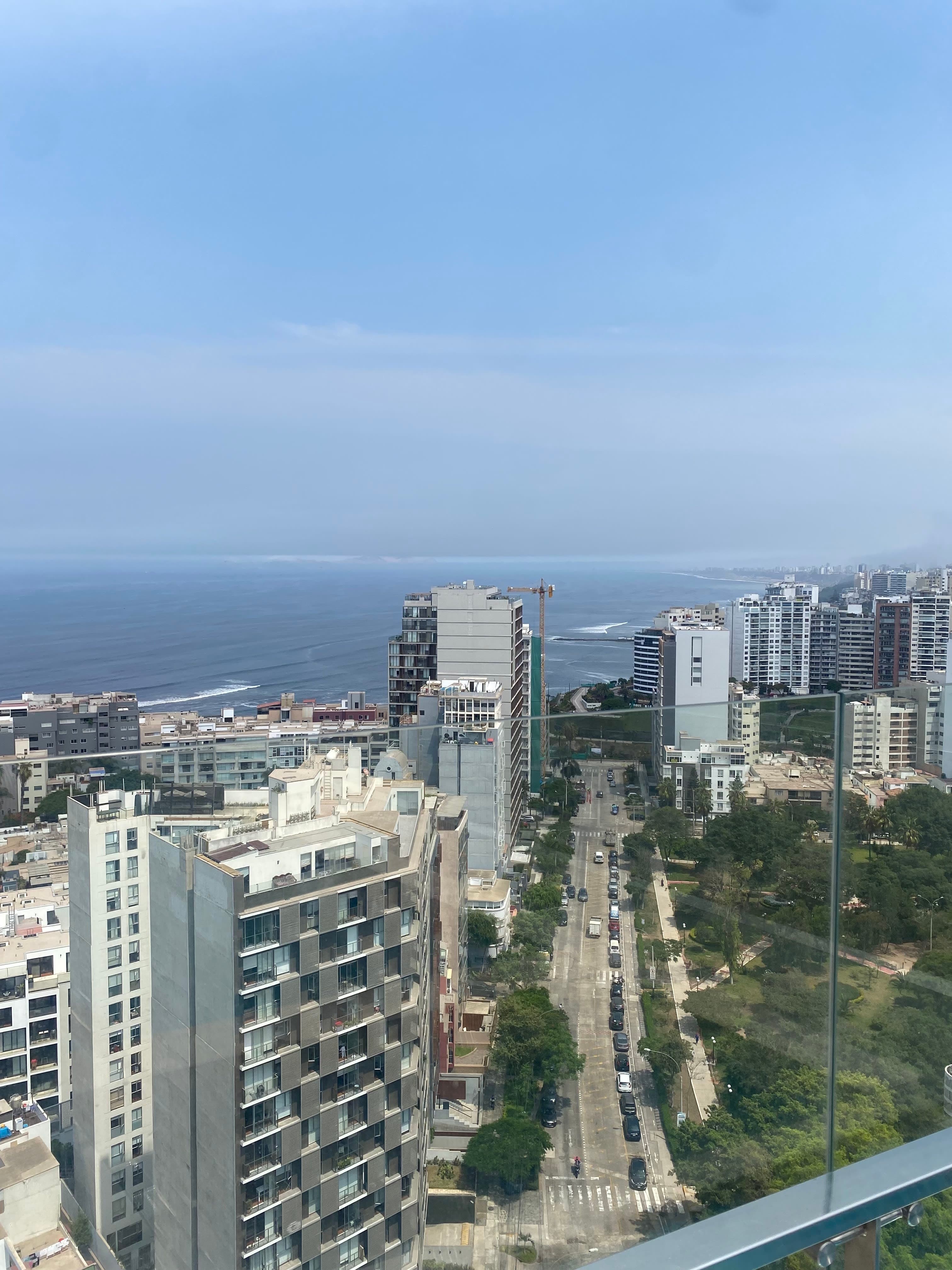 View of Lima from a balcony, with city buildings by the ocean