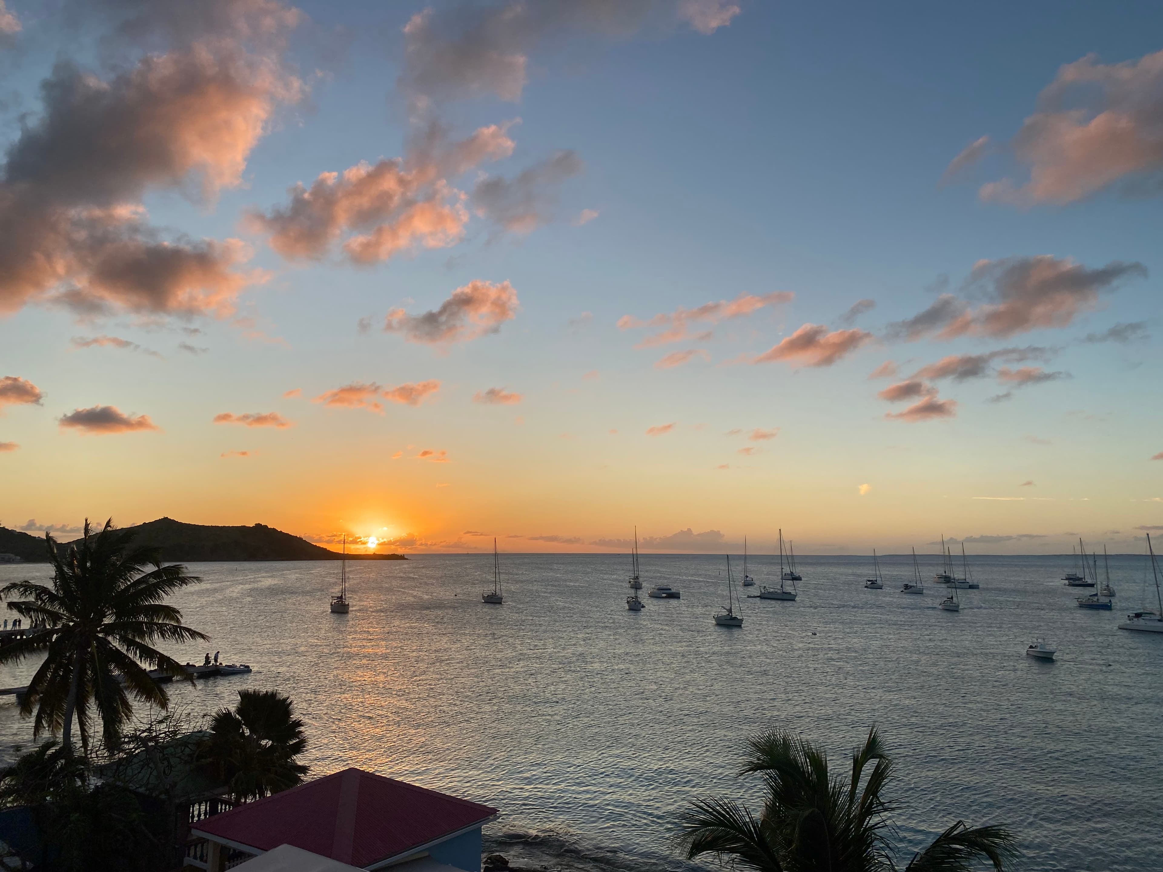 View of boats in the sea at sunset