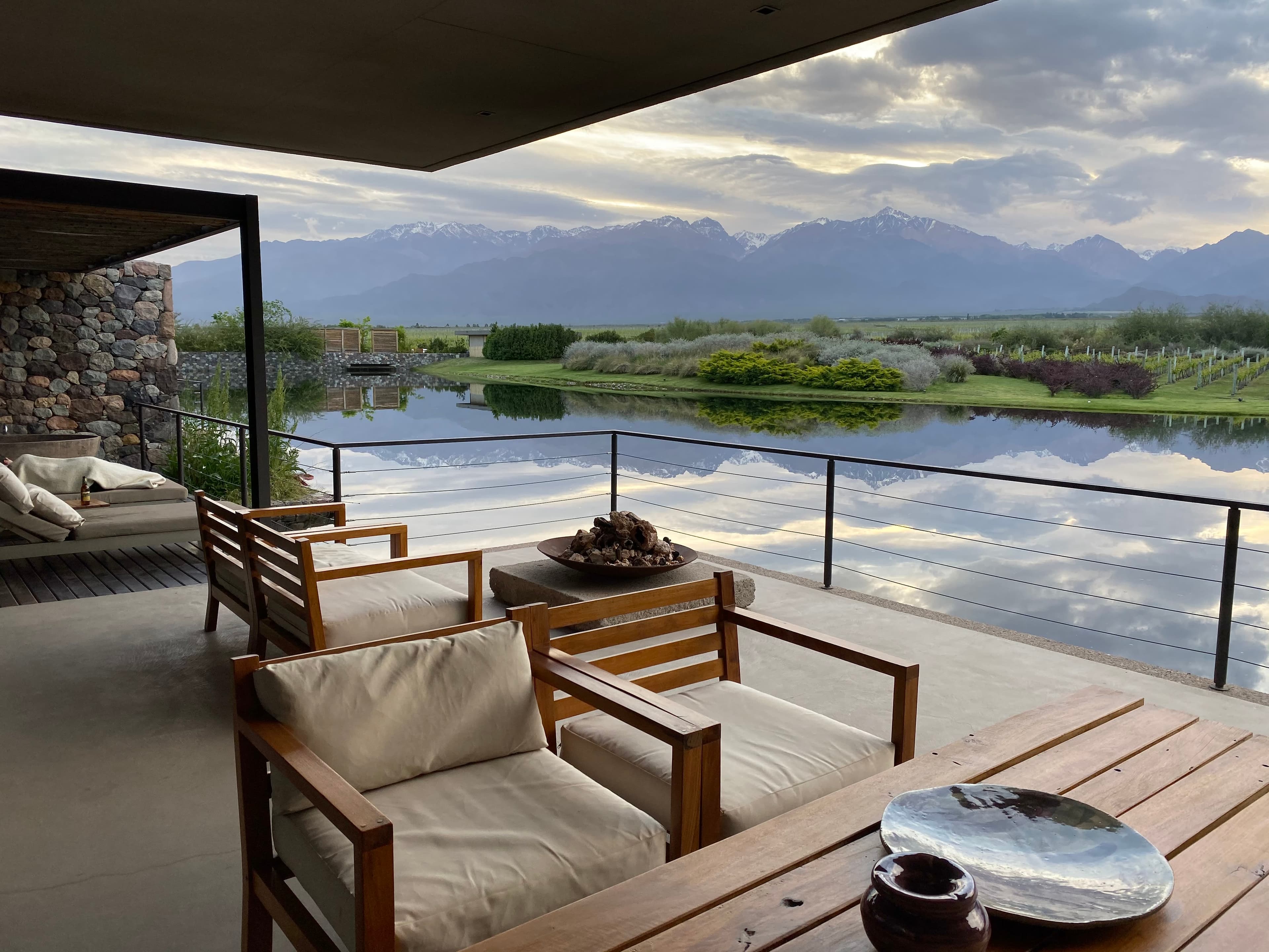 Outdoor deck area with patio furniture overlooking a lake
