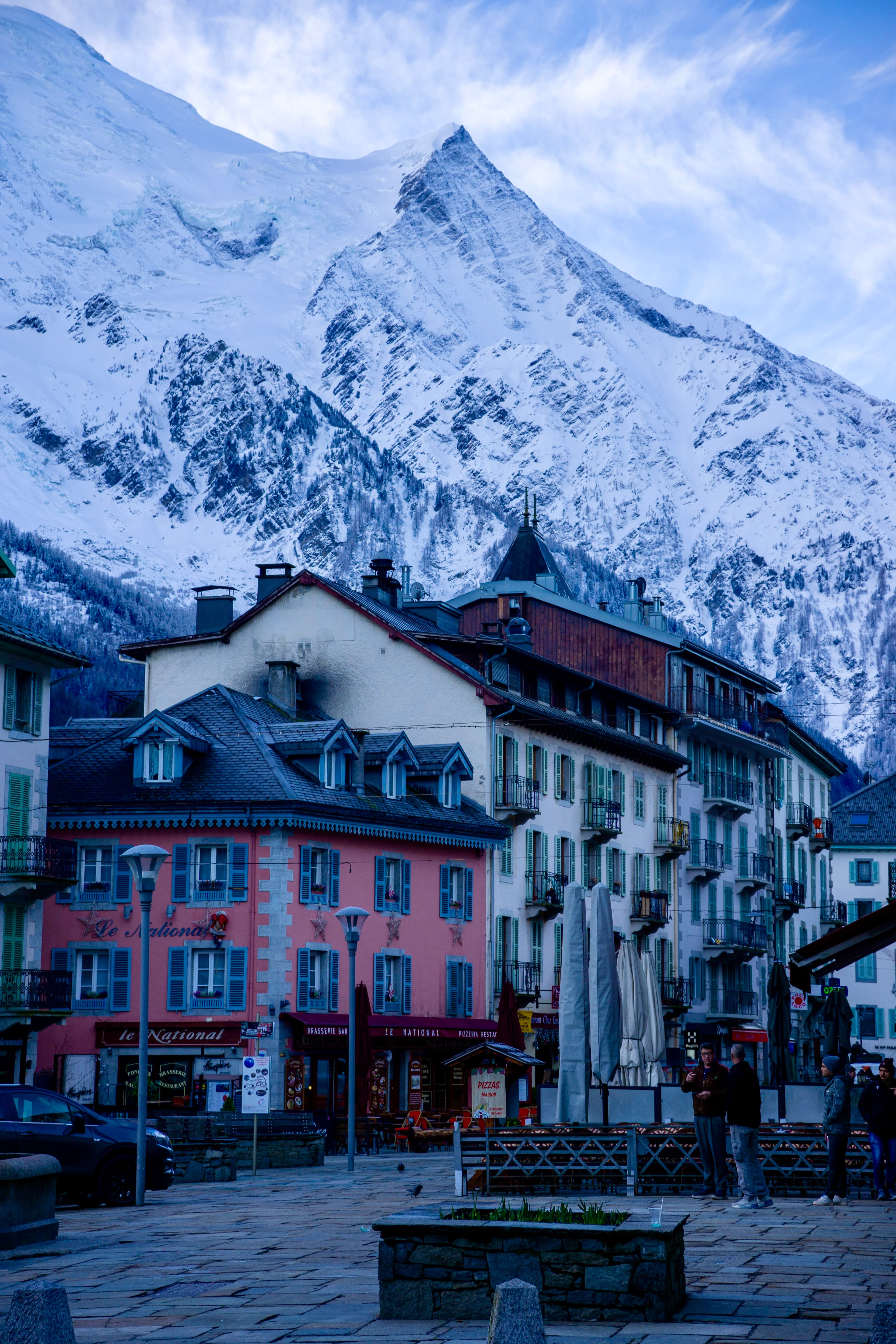 View of colorful buildings with snowy mountains in the background