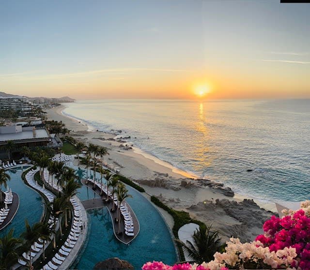 Beautiful view of sunset over the sea and a beachfront resort