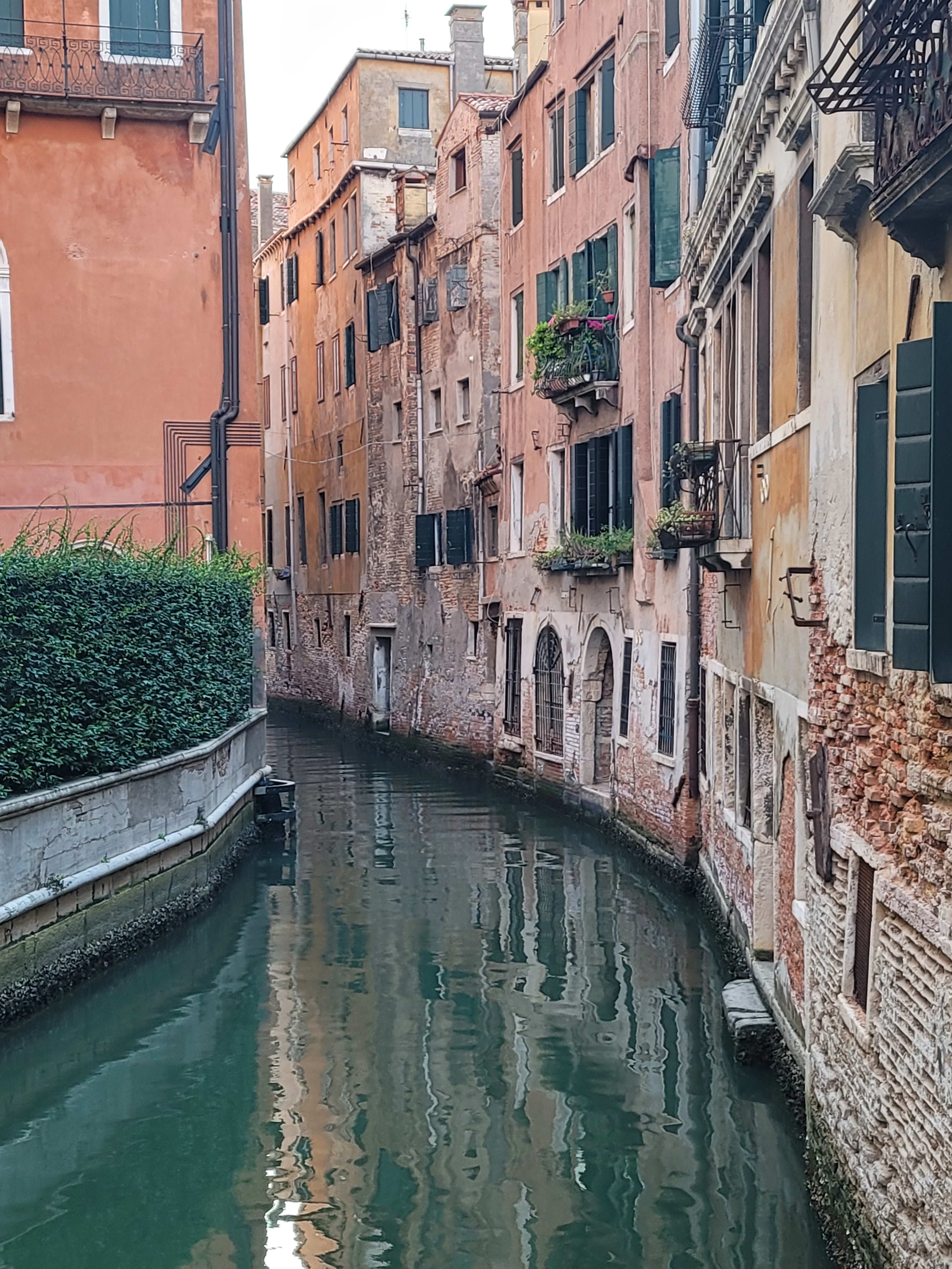 Beautiful canal with quaint buildings either side in Venice, Italy