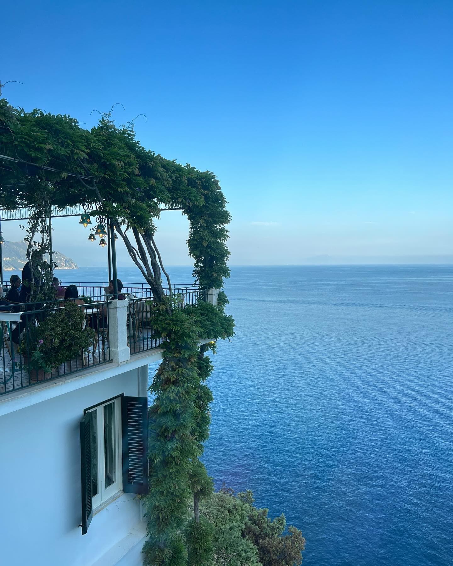 An oceanside balcony covered in moss at the Santa Caterina Hotel
