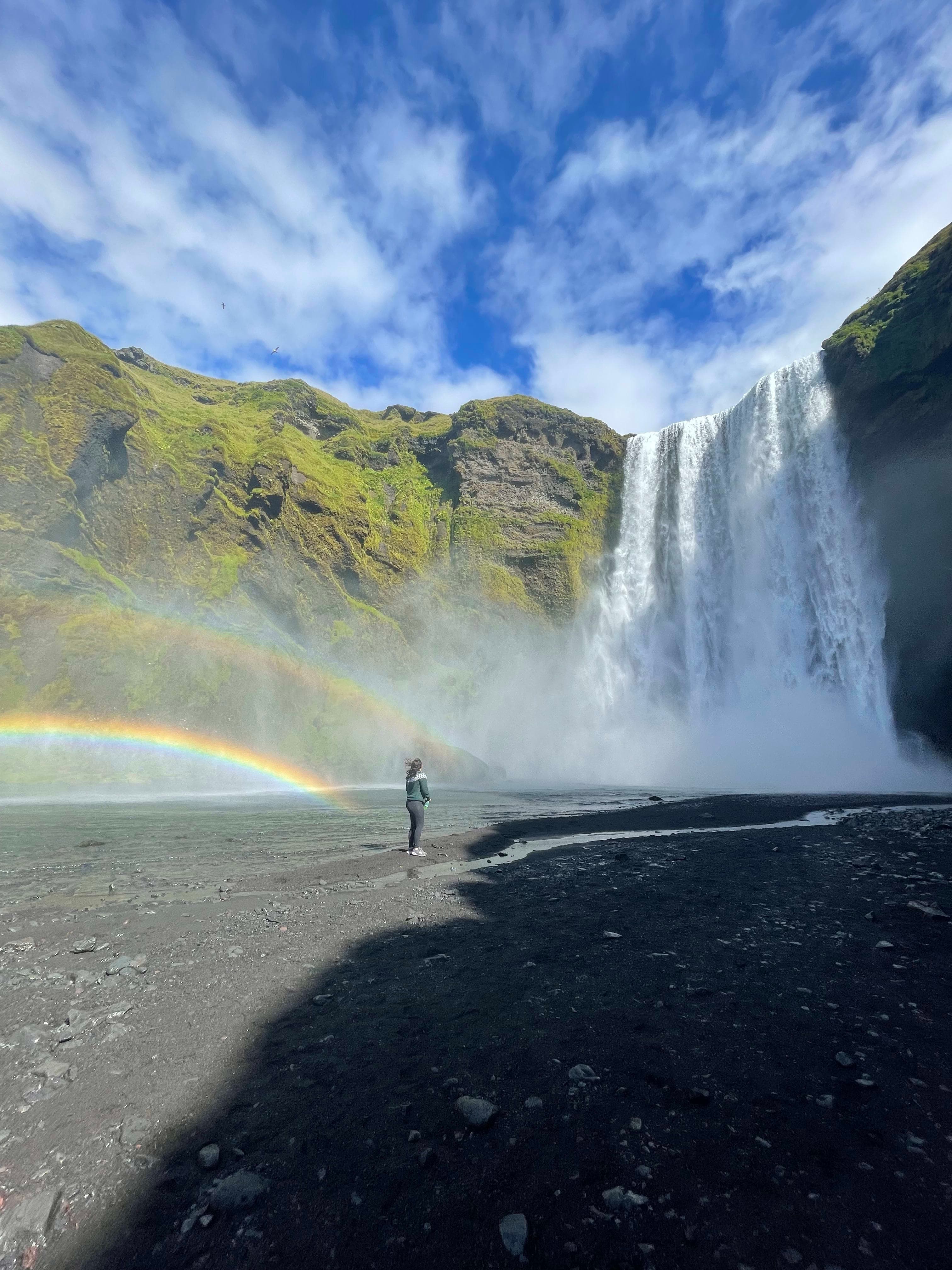 Double rainbows by a waterfall