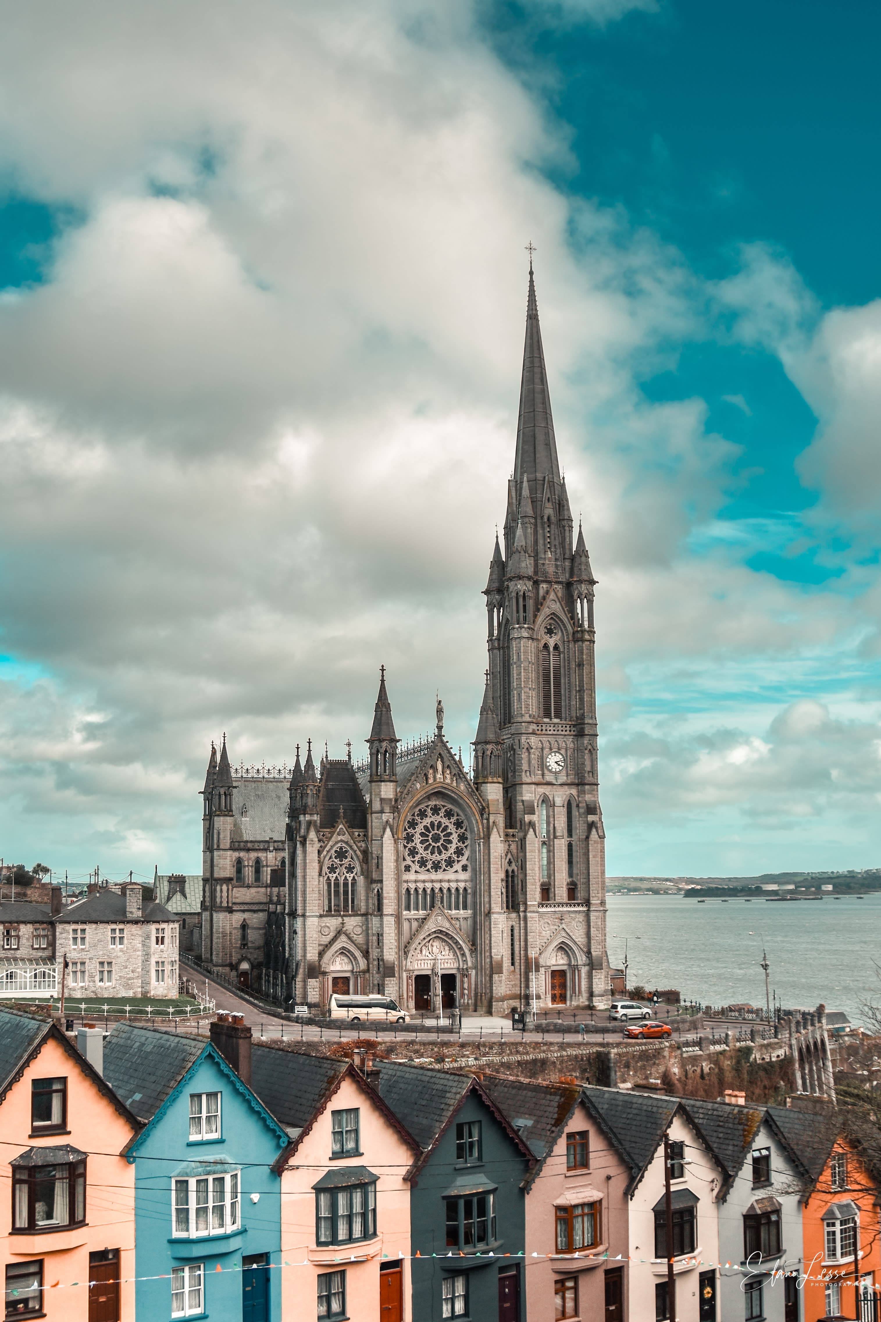 Colorful Cobh Cathedral houses in front of a cathedral on the water