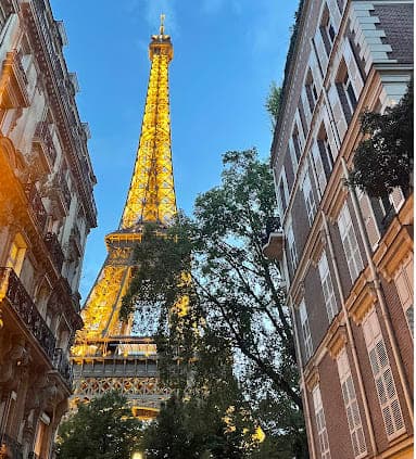 Eiffel Tower as seen from between buildings and trees