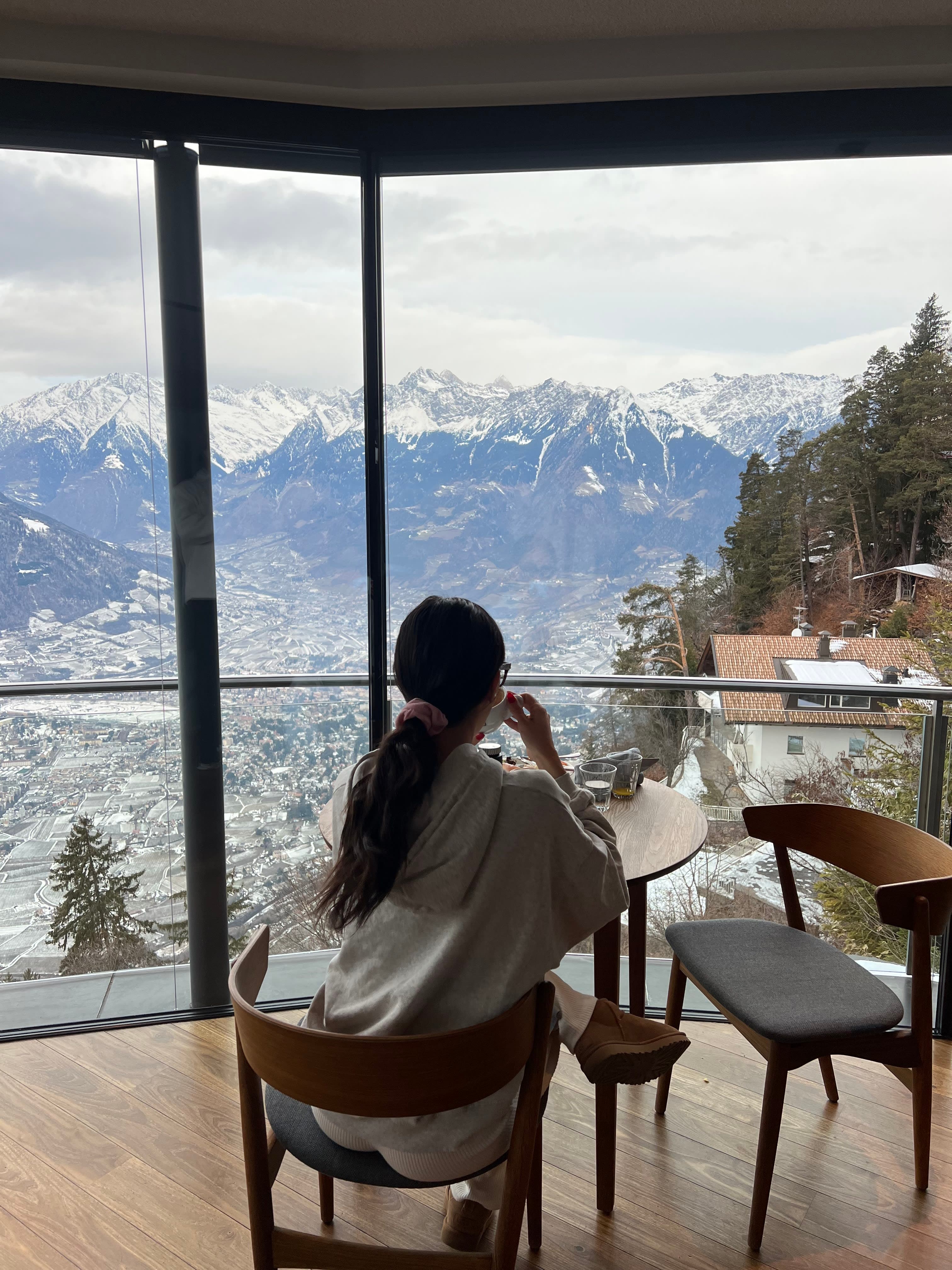 Having a cup of coffee with the beautiful view of snow capped mountains