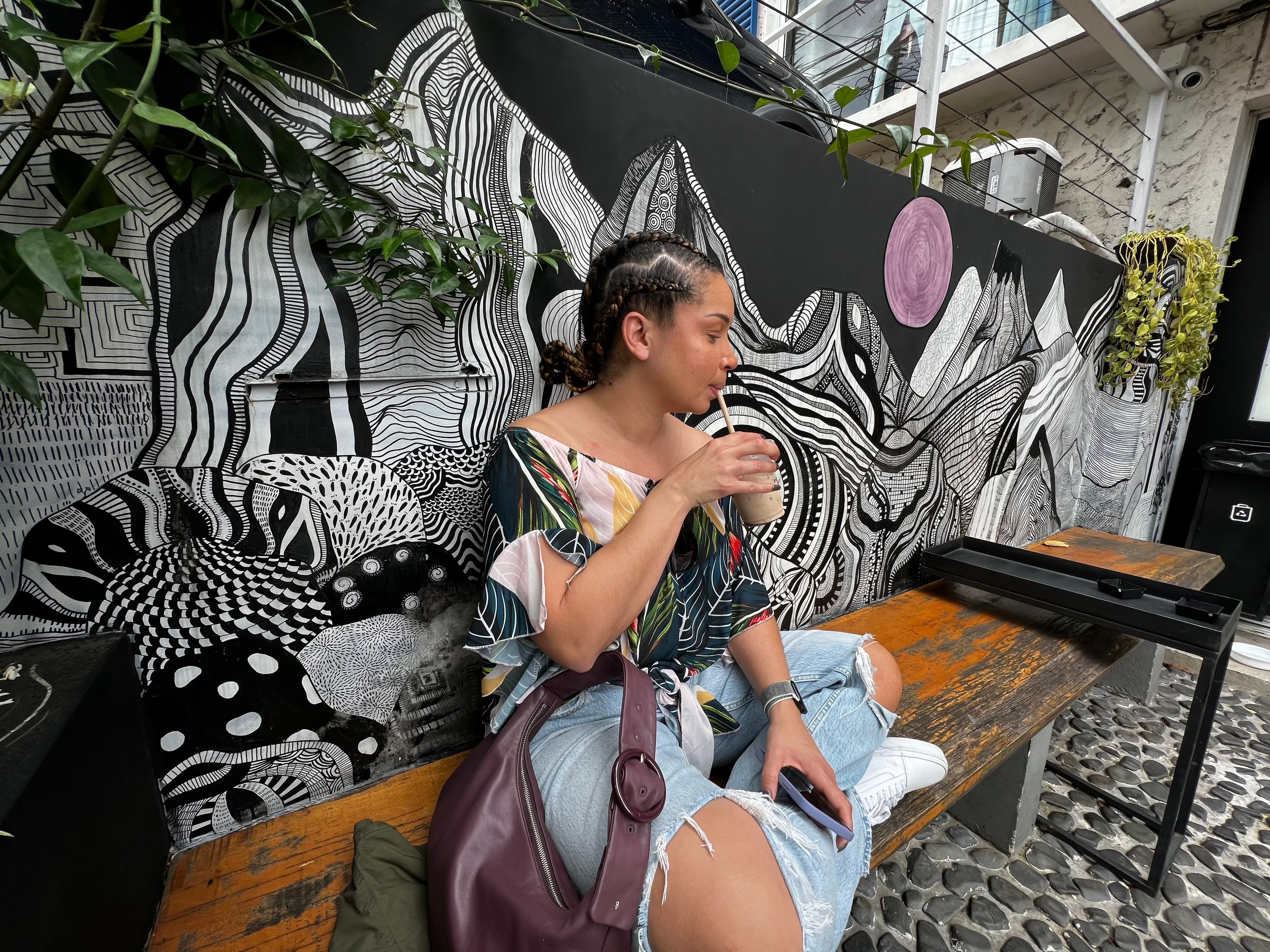 Sitting on a bench and having an iced coffee