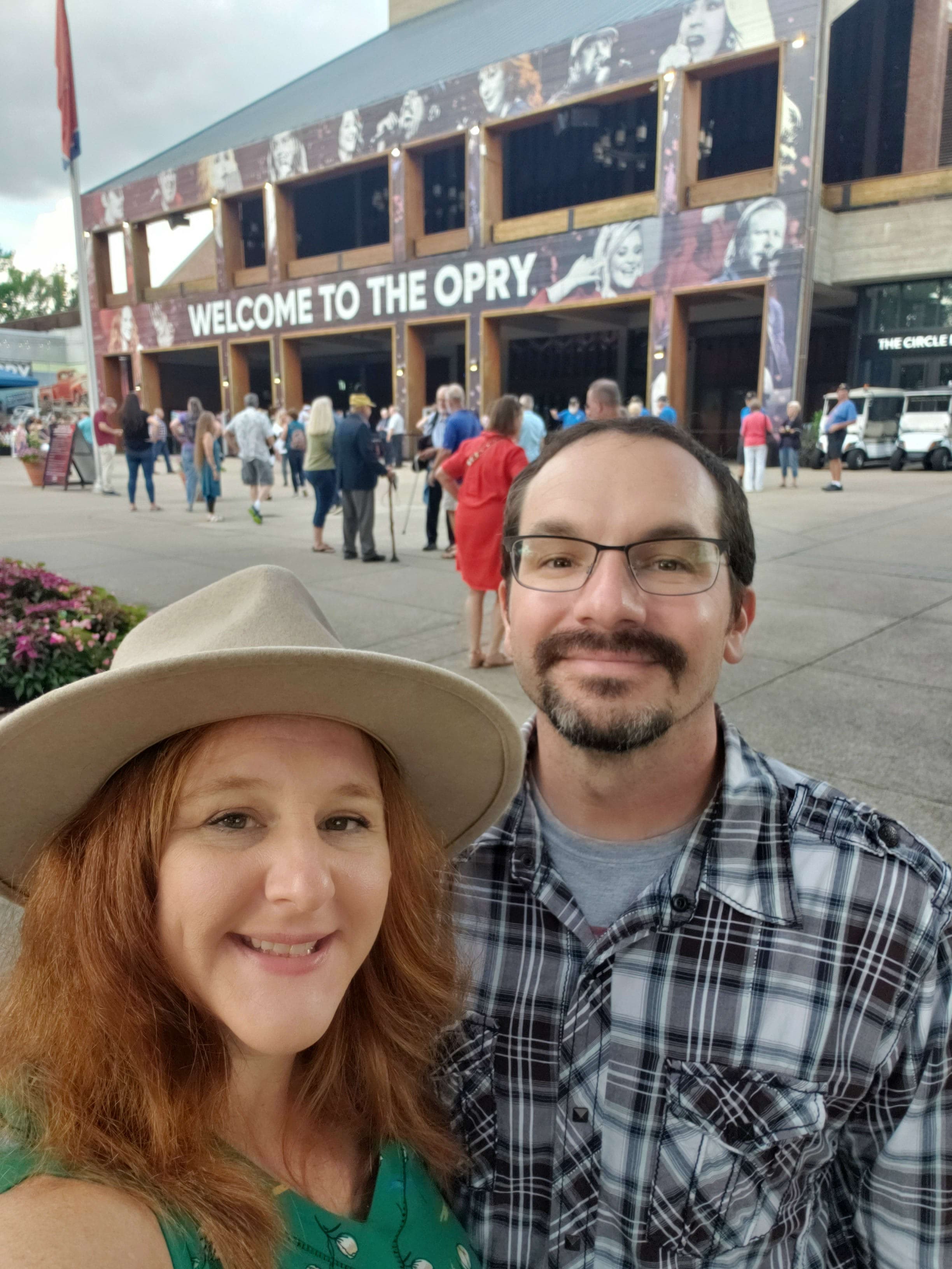 A selfie of Angela and a man in front of the Grand Ole Opry