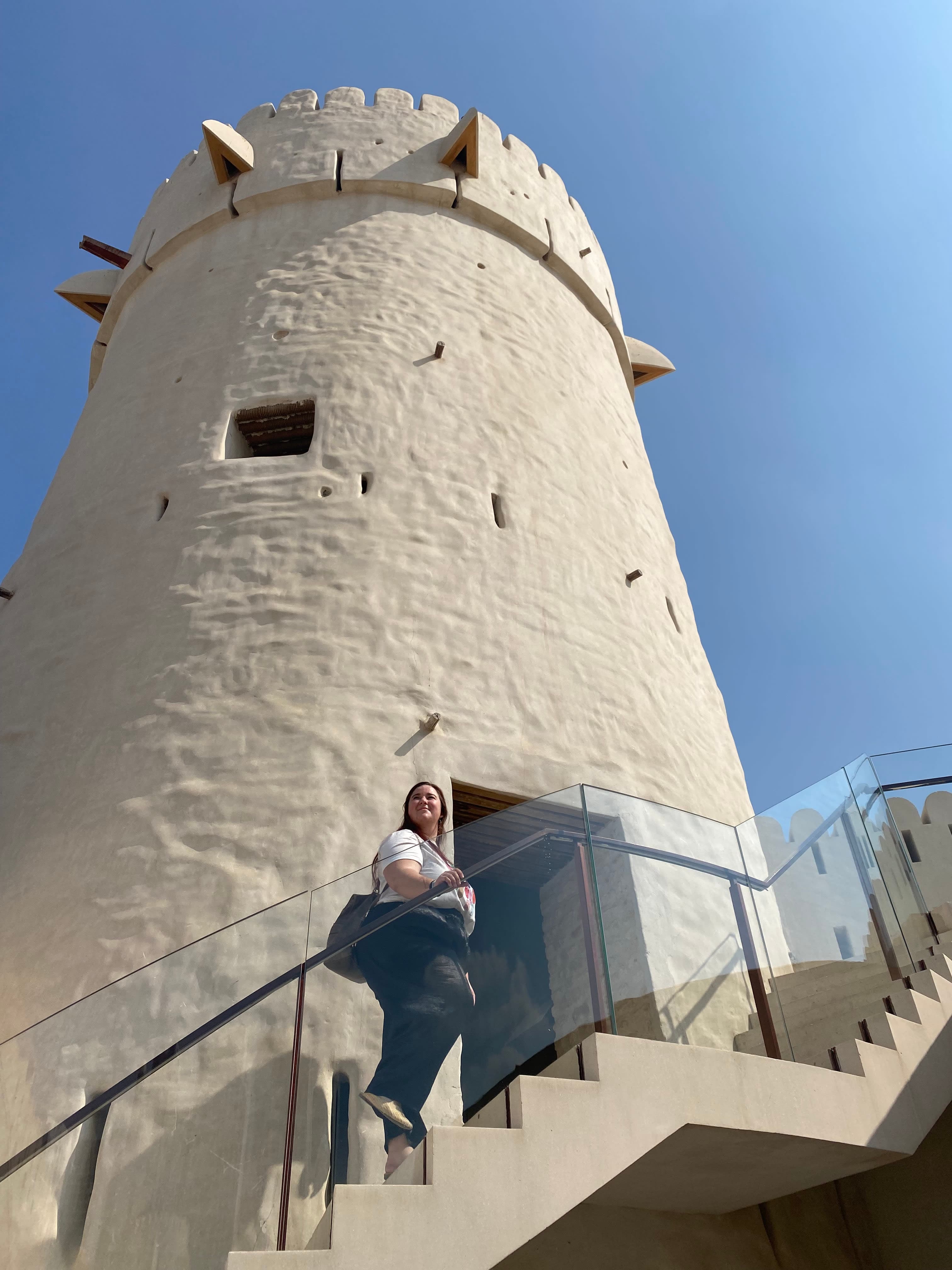 Erika walking up the stairs of Qasr Al Hosn Fortress