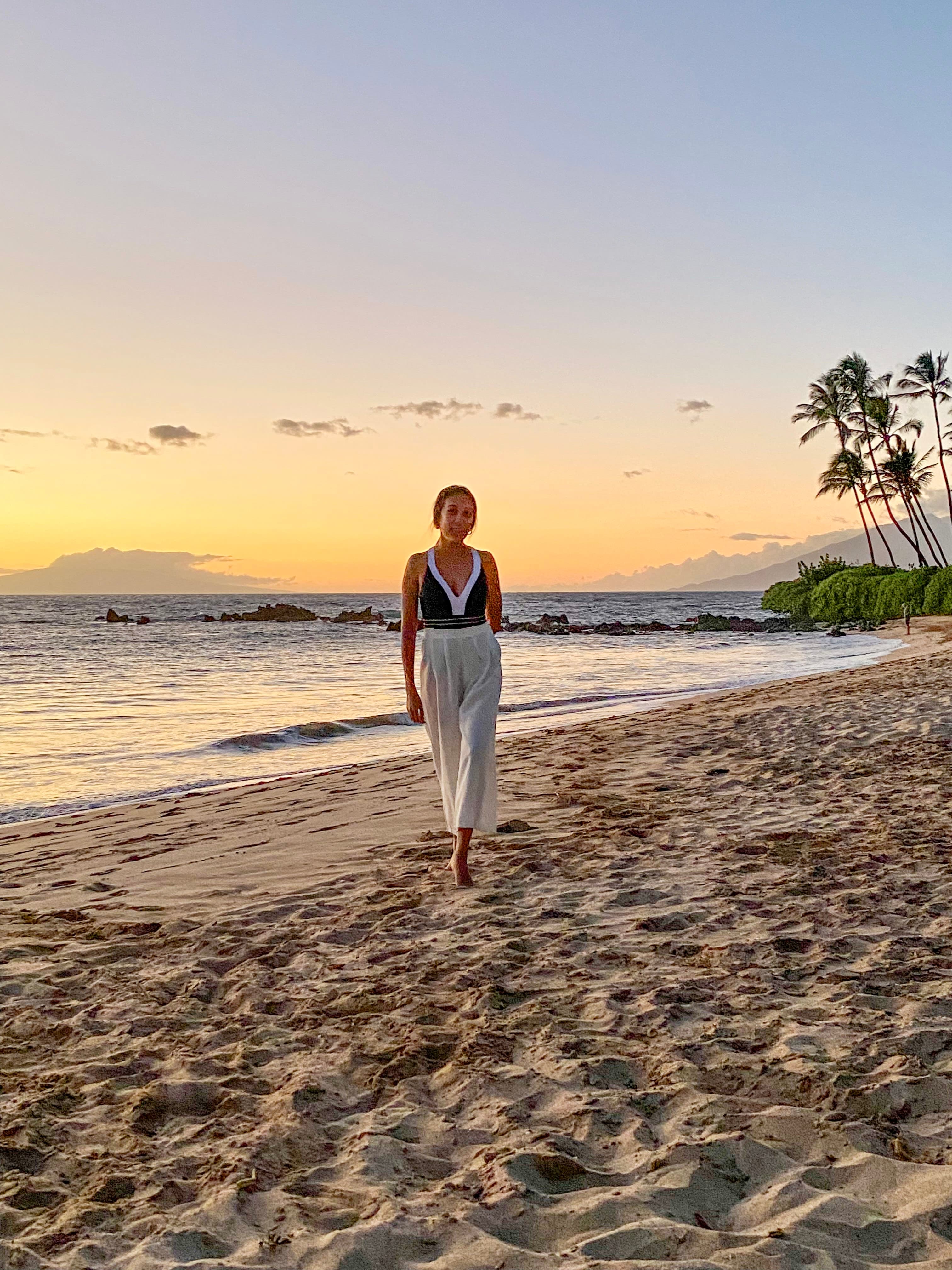 Pam casually strolling on Maui beach at sunset