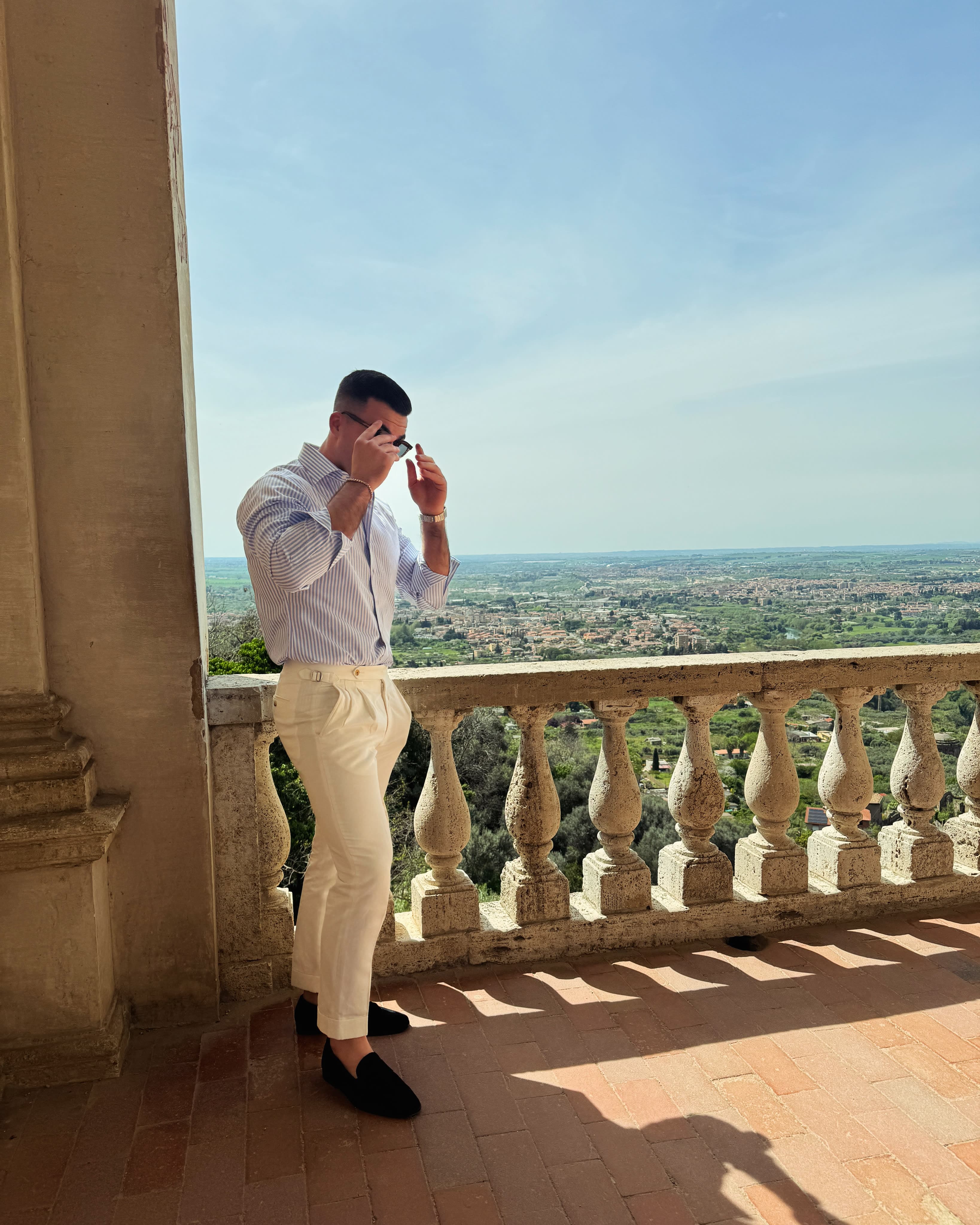 Grayson standing on the balcony of Villa d'Este and enjoying the view