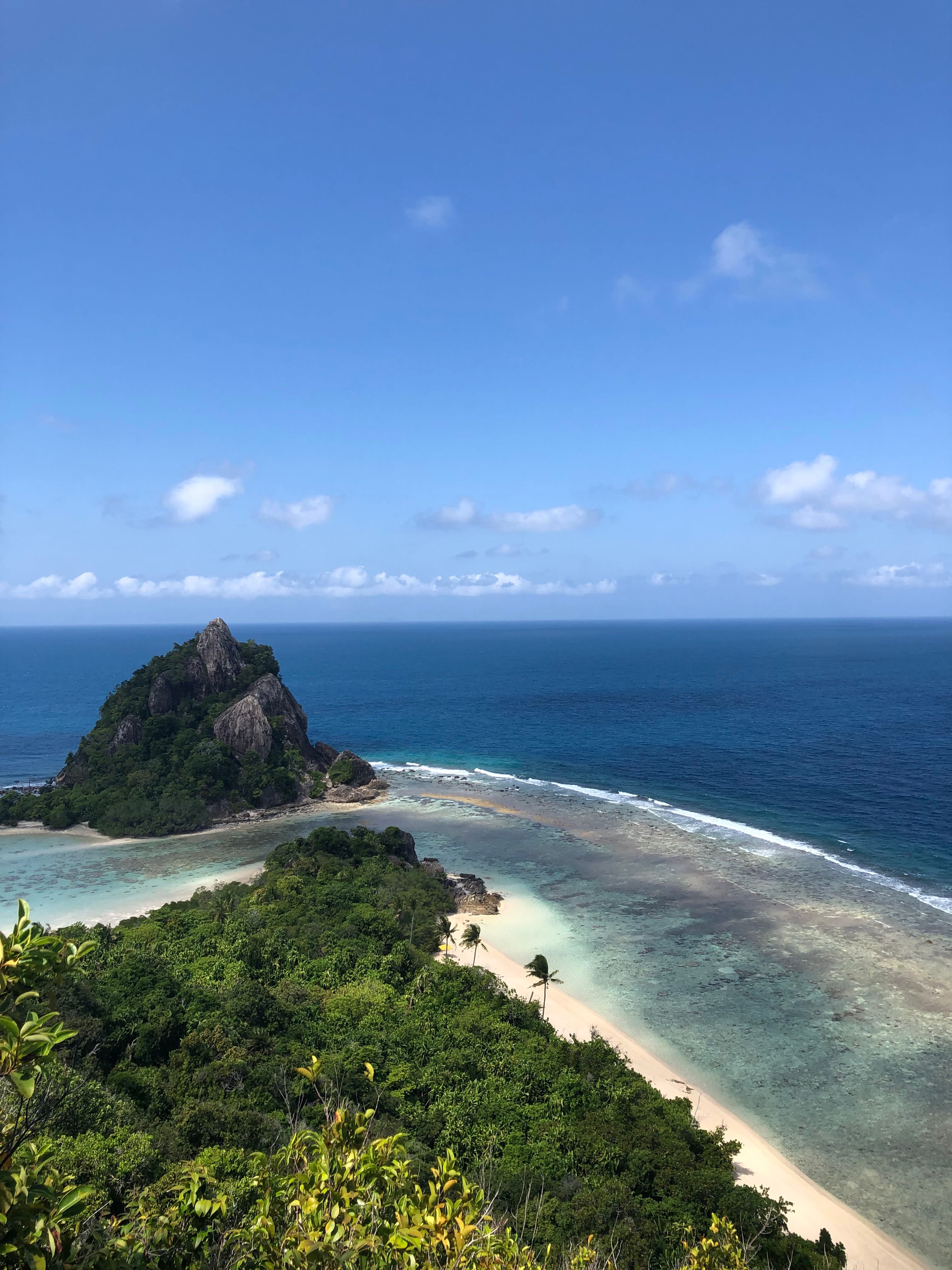 Beautiful view of the white sand and lush jungle at Bawah Coconut Beach
