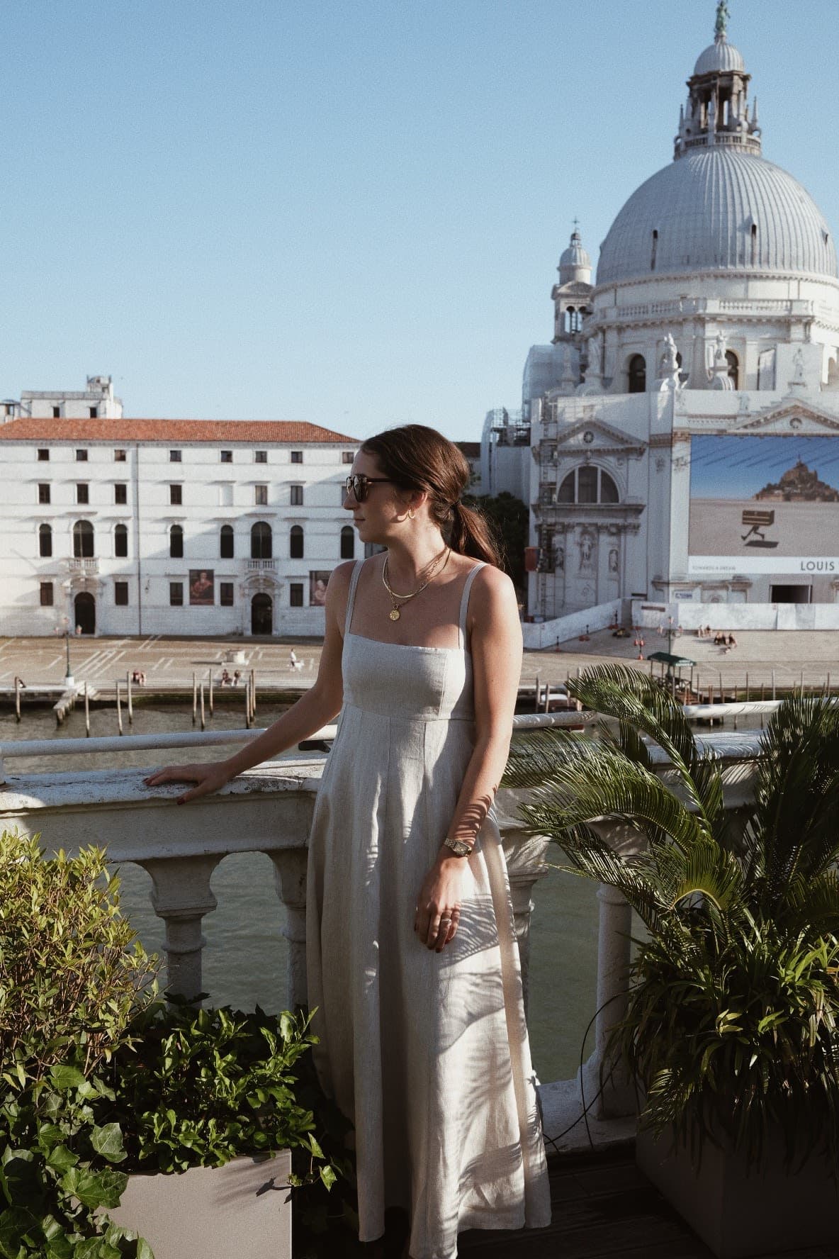 Ally Barnes in a green dress posing for a photo with Adare Manor in view