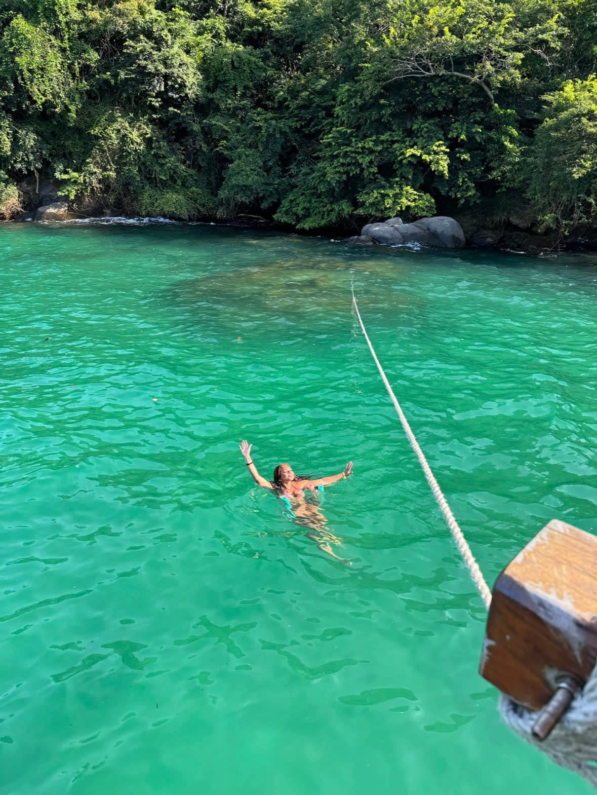 A girl swimming in a turquoise sea.