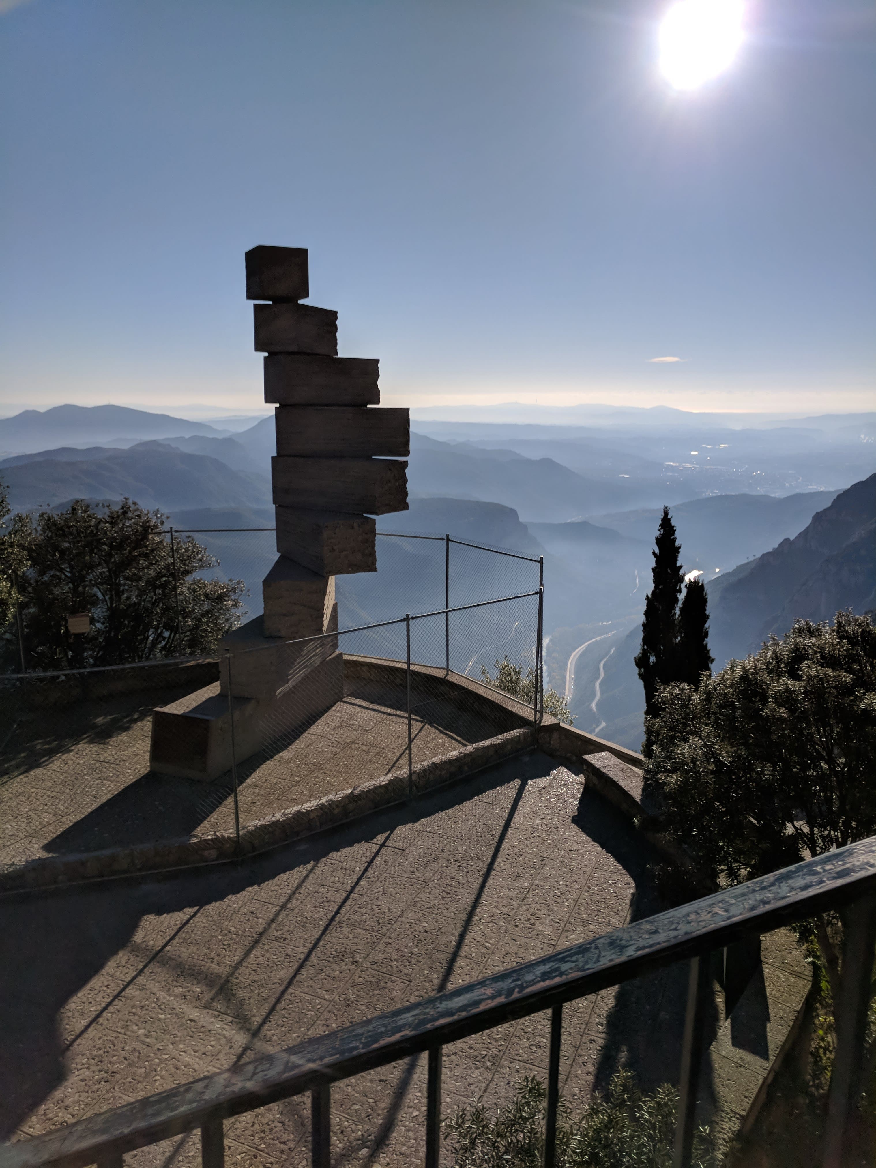 Beautiful view of a modern sculpture atop Mont Serrat with a vista of mountains in the background