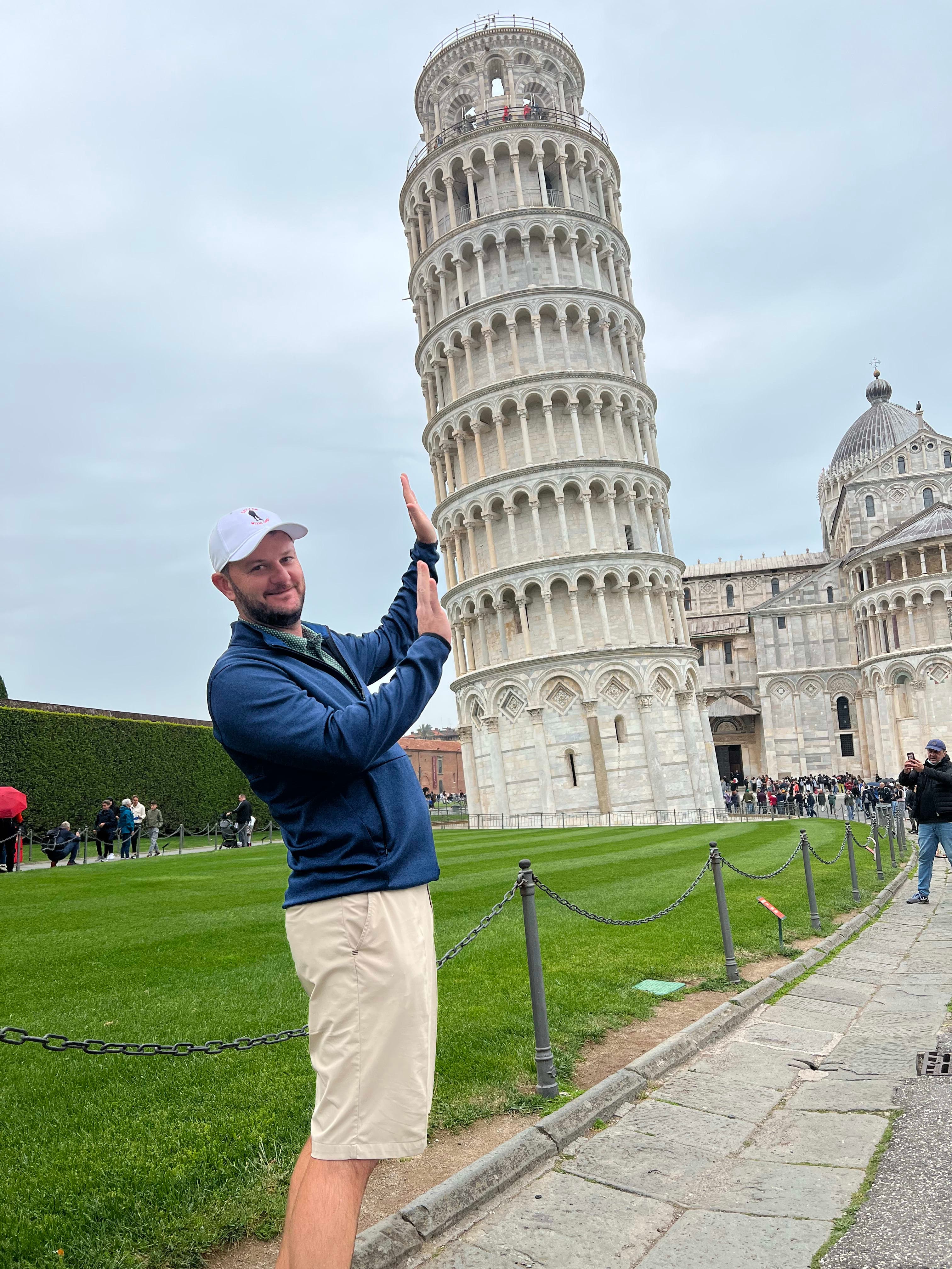 Man posing at Leaning Tower of Pisa