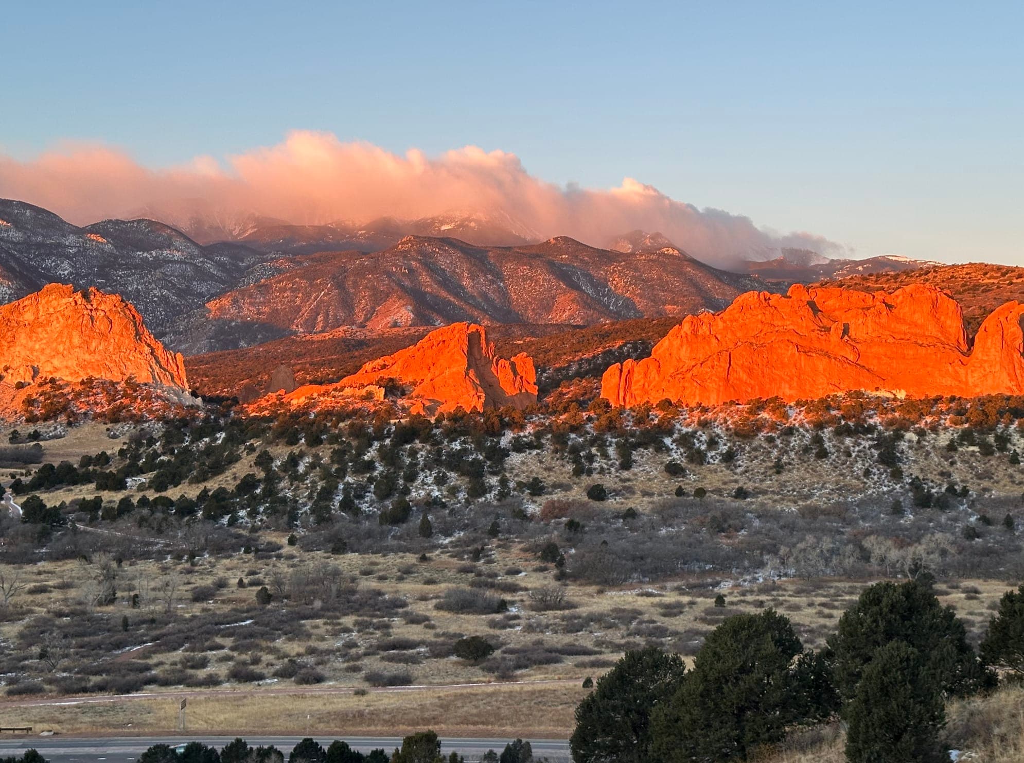 Beautiful view of a rocky landscape within Garden of the Gods park lit up with orange sunlight