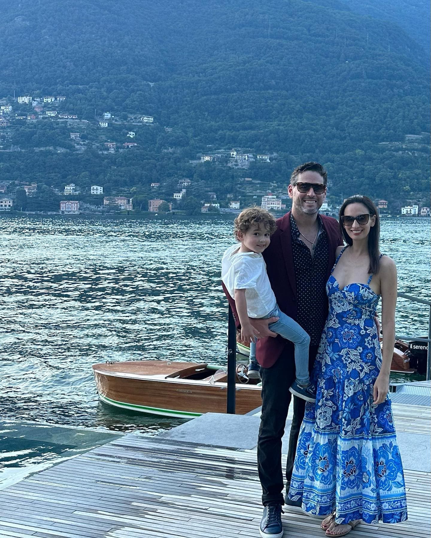 Picture of Mindy in a long blue dress standing on a dock with family