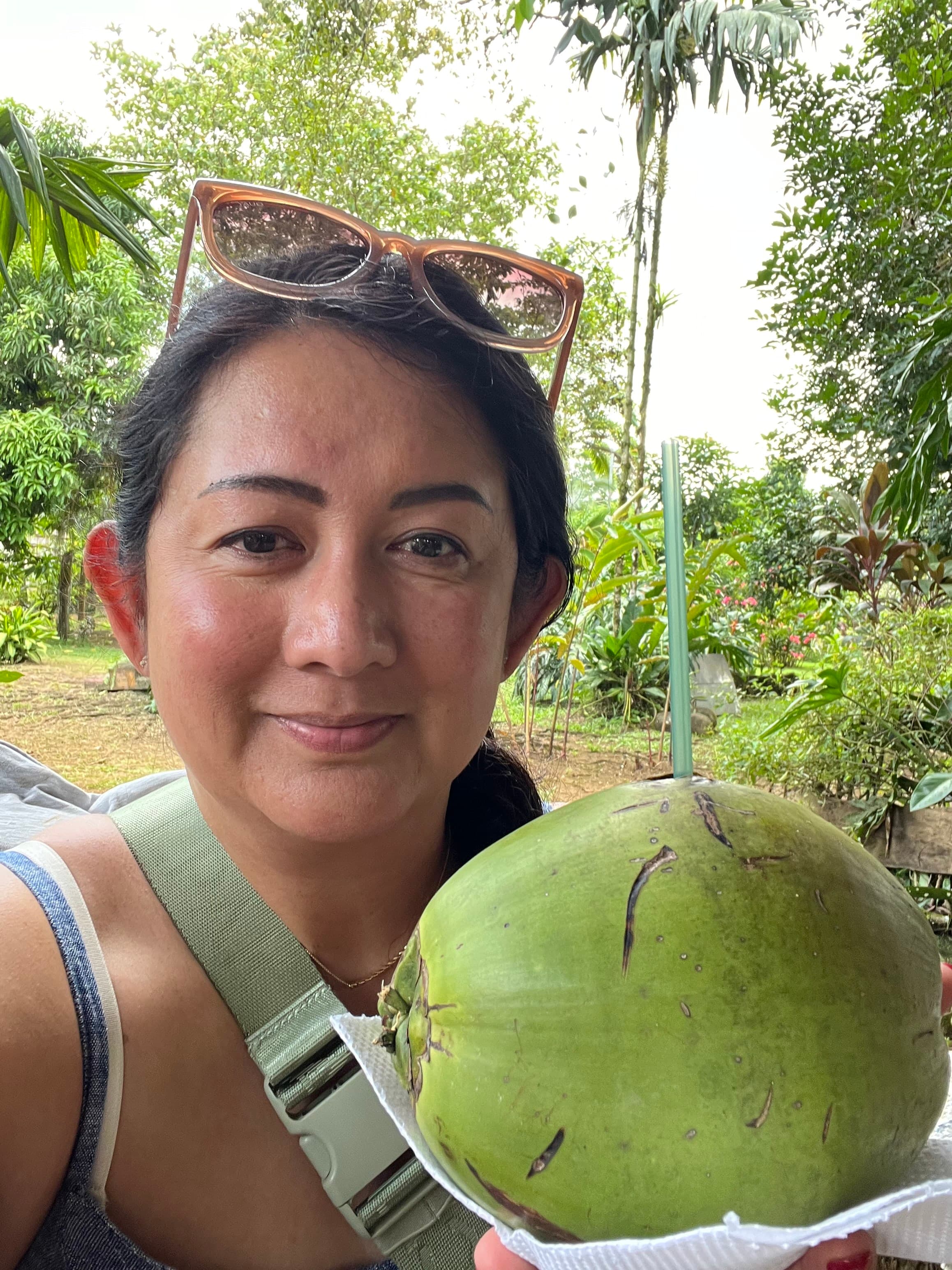Picture of Hazel holding a large green coconut with a straw sticking out of the top
