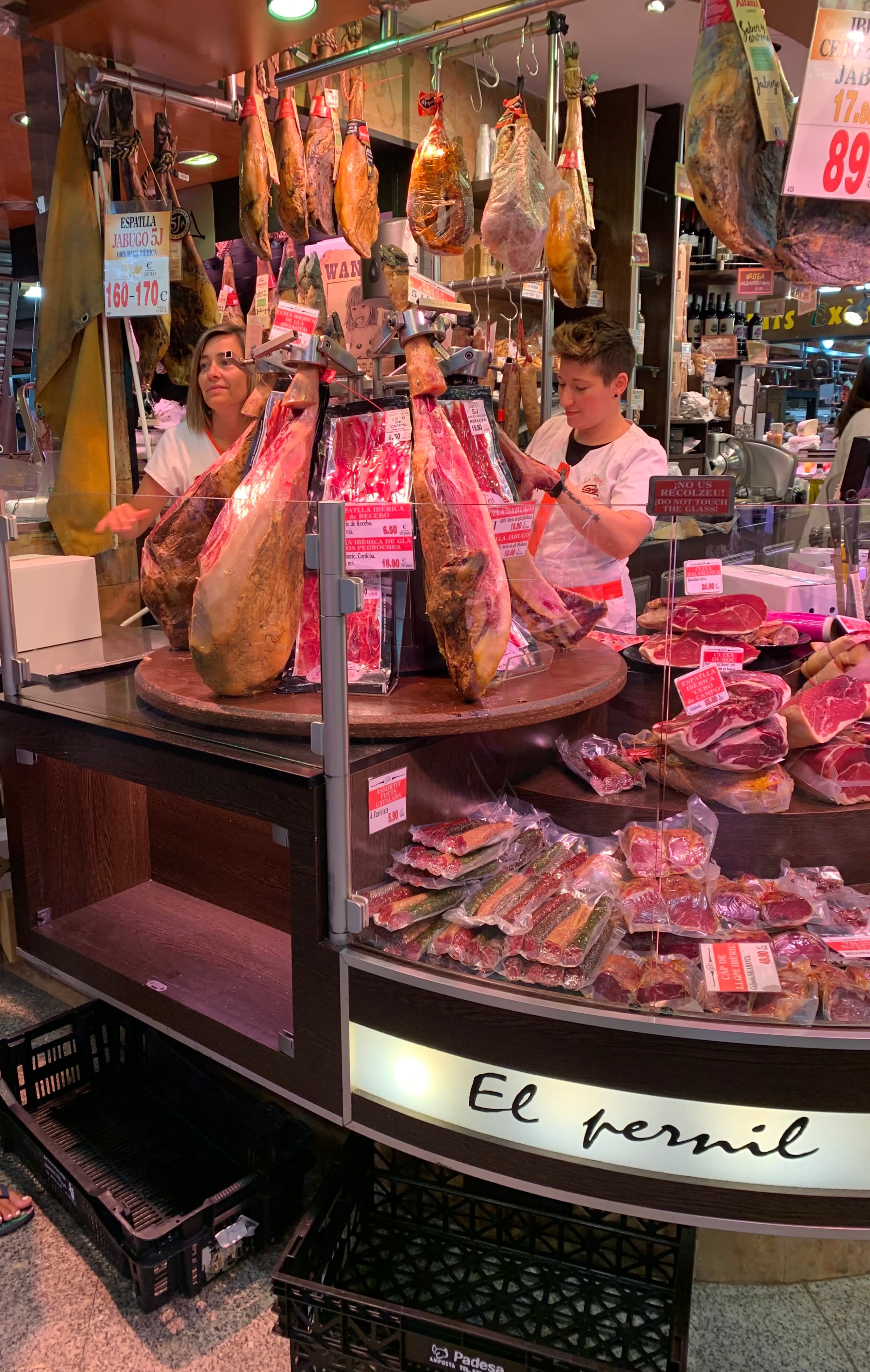 View of a meat shop with a man and a women standing behind the counter