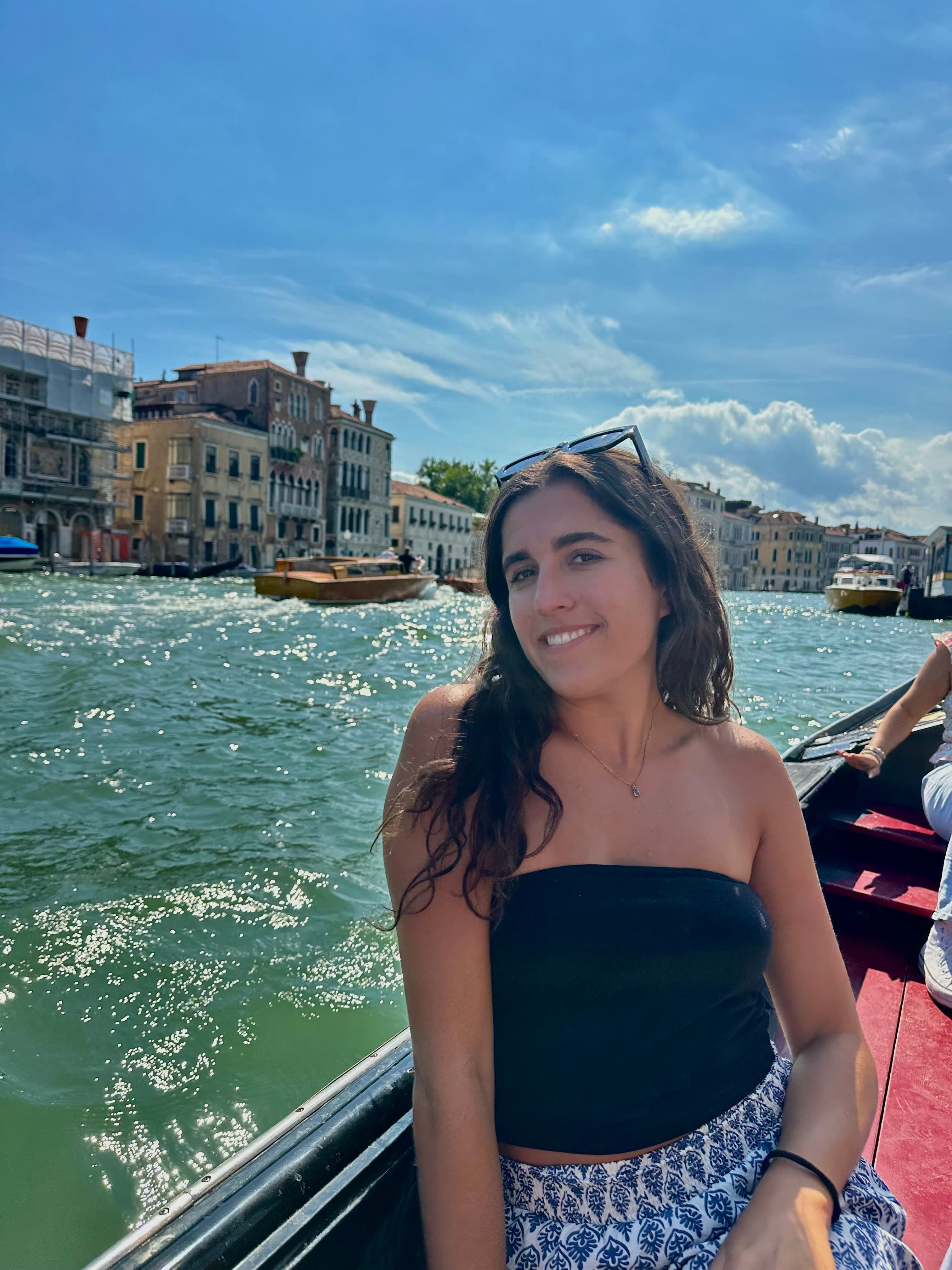 Avery in a black top sitting on a boat for a tour along the city coast