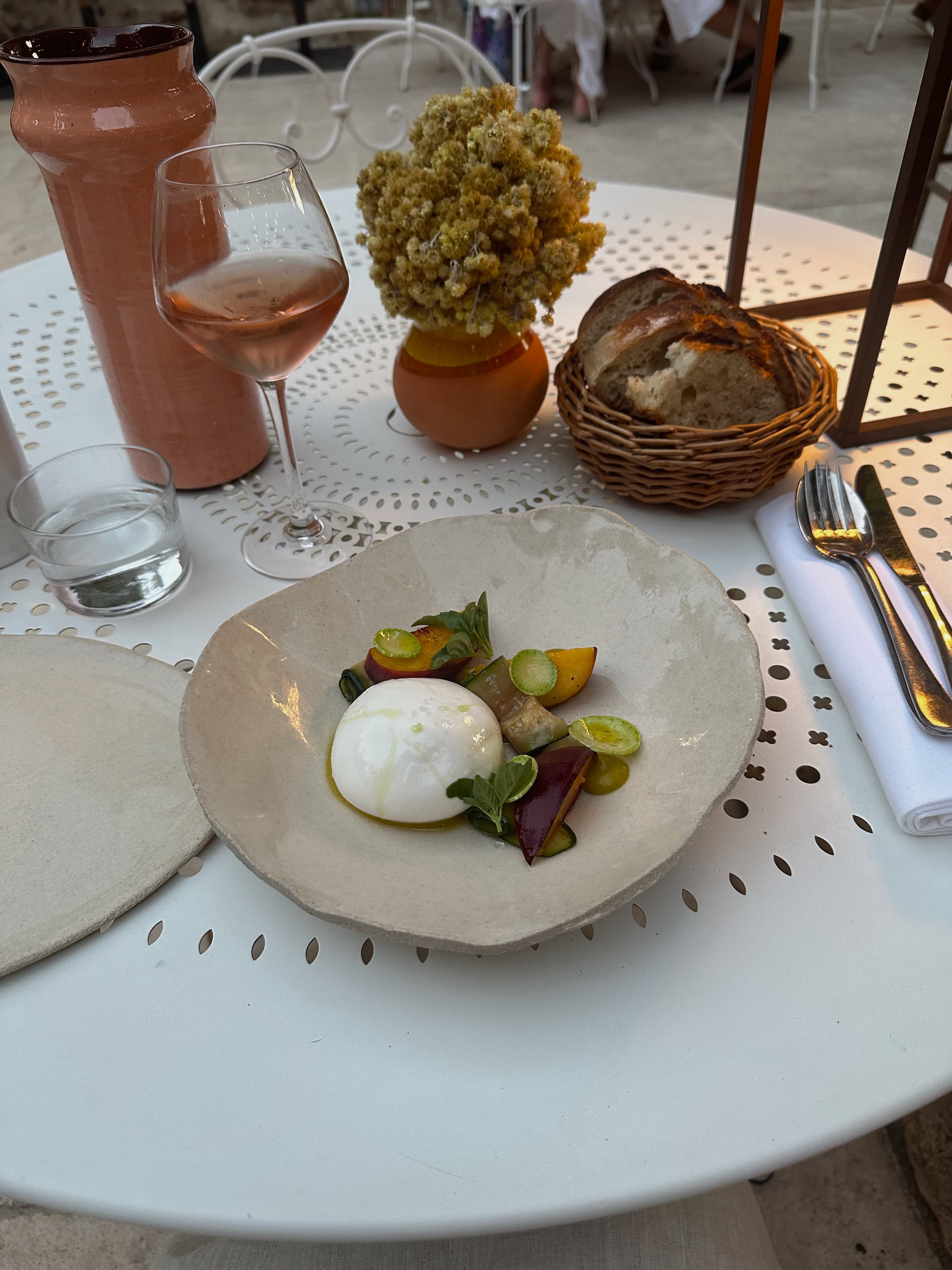 Having a fancy plate of food with cheese, fruits and veggies for lunch at a restaurant