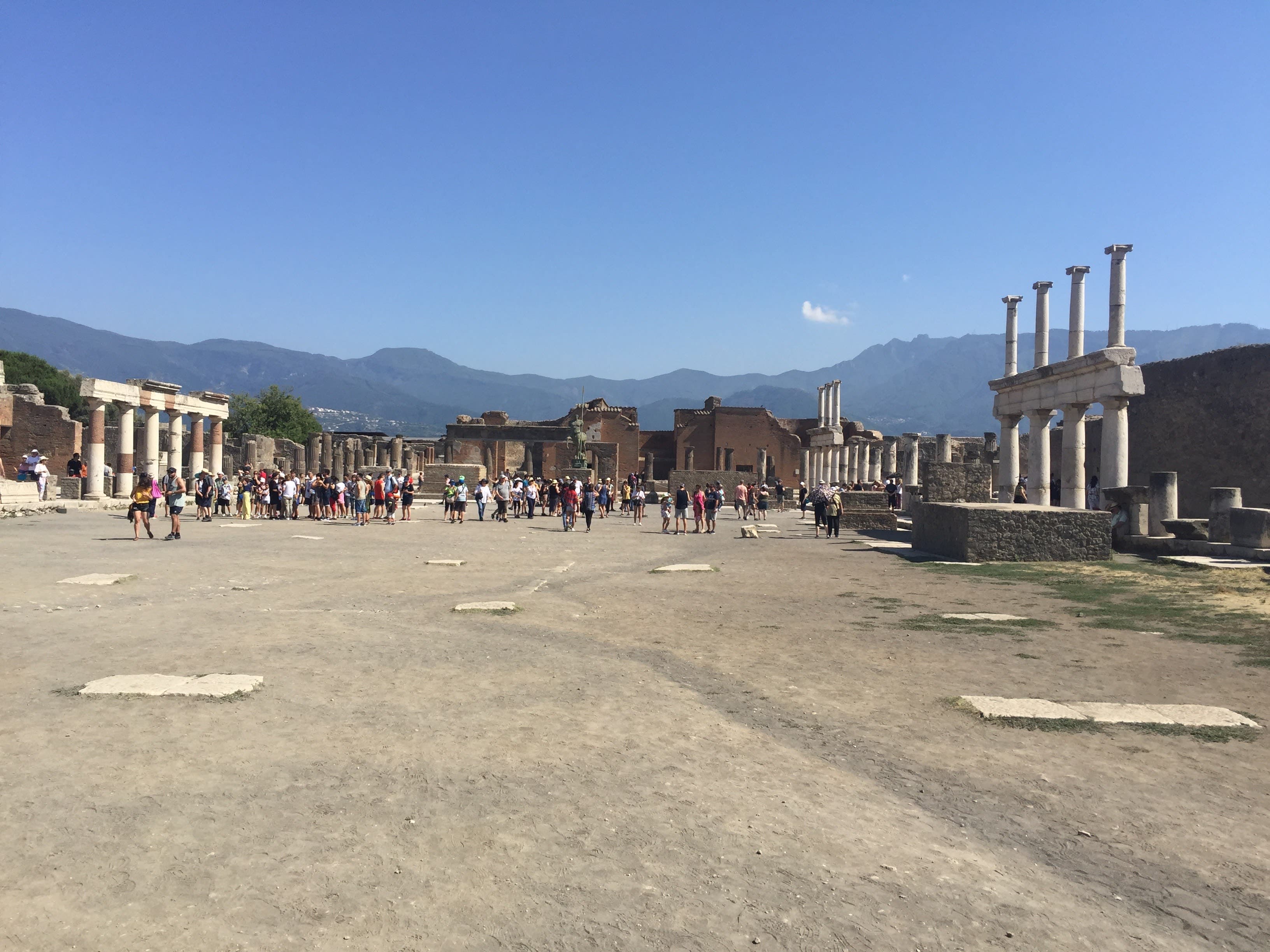 Sunny view of ancient archaeological ruins with a mountain landscape in the distance