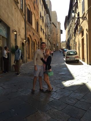 Picture of Kenny with girlfriend in the middle of the street with beautiful old buildings on either side