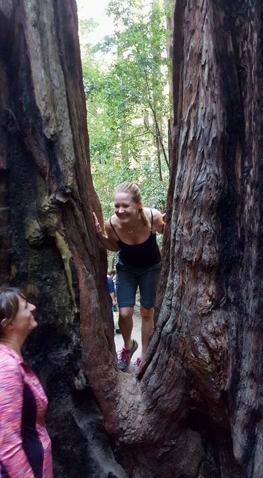 Advisor posing for an image with a tree during the daytime.