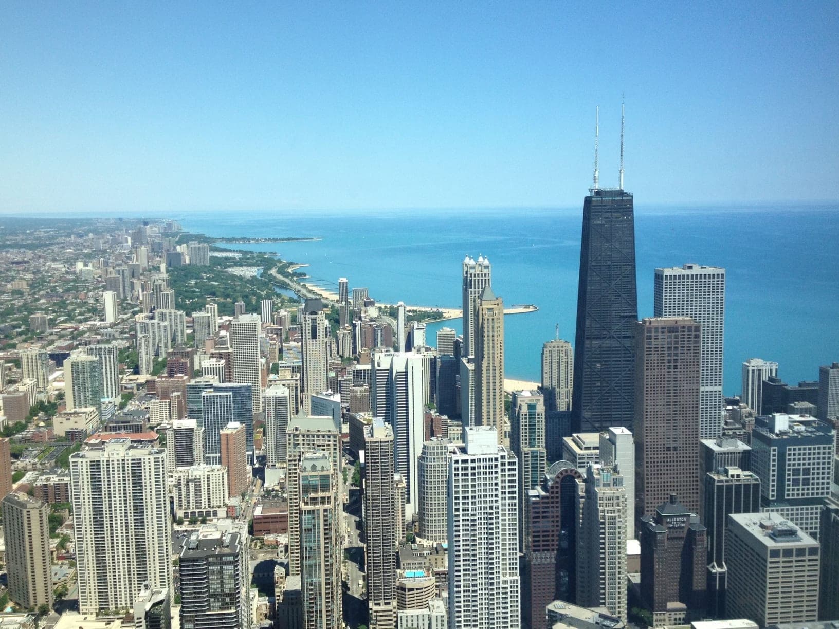 An image of a city with the ocean in the distance on a sunny day.