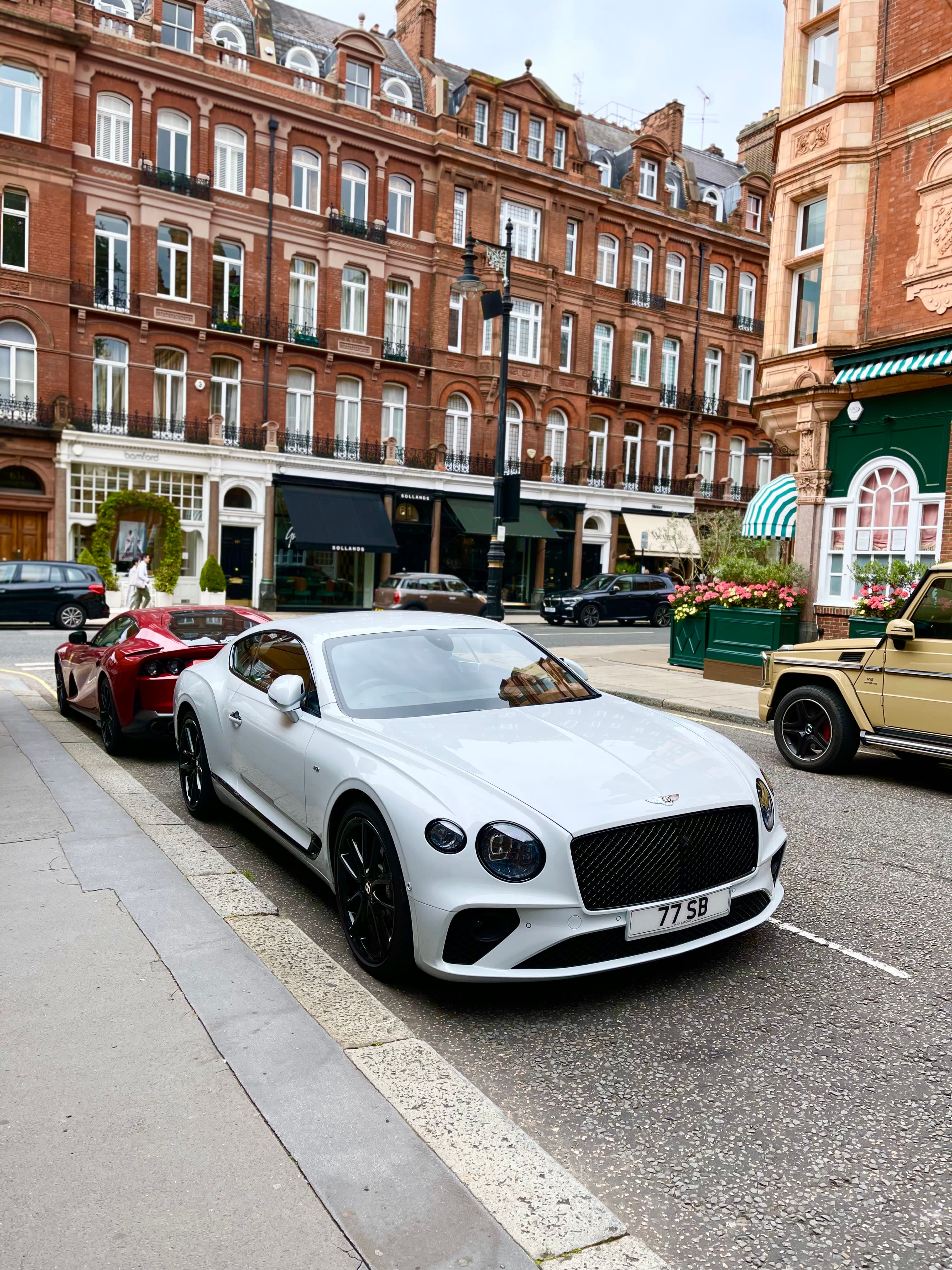 Image of an expensive white car on a sunny day.