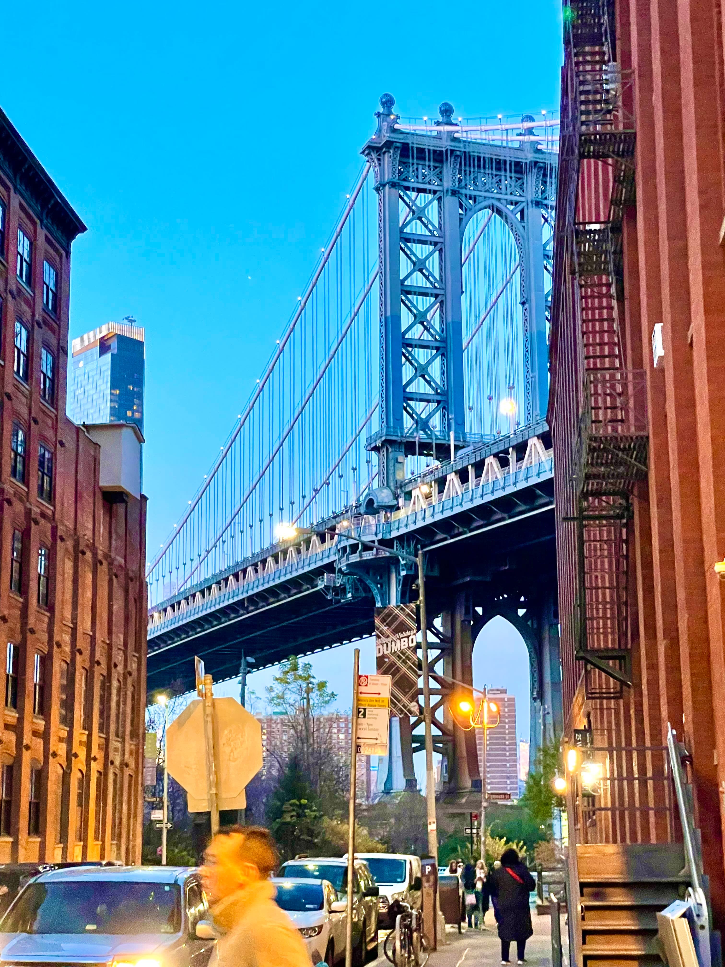 View of the Manhattan Bridge as seen from a street in Brooklyn at sundown