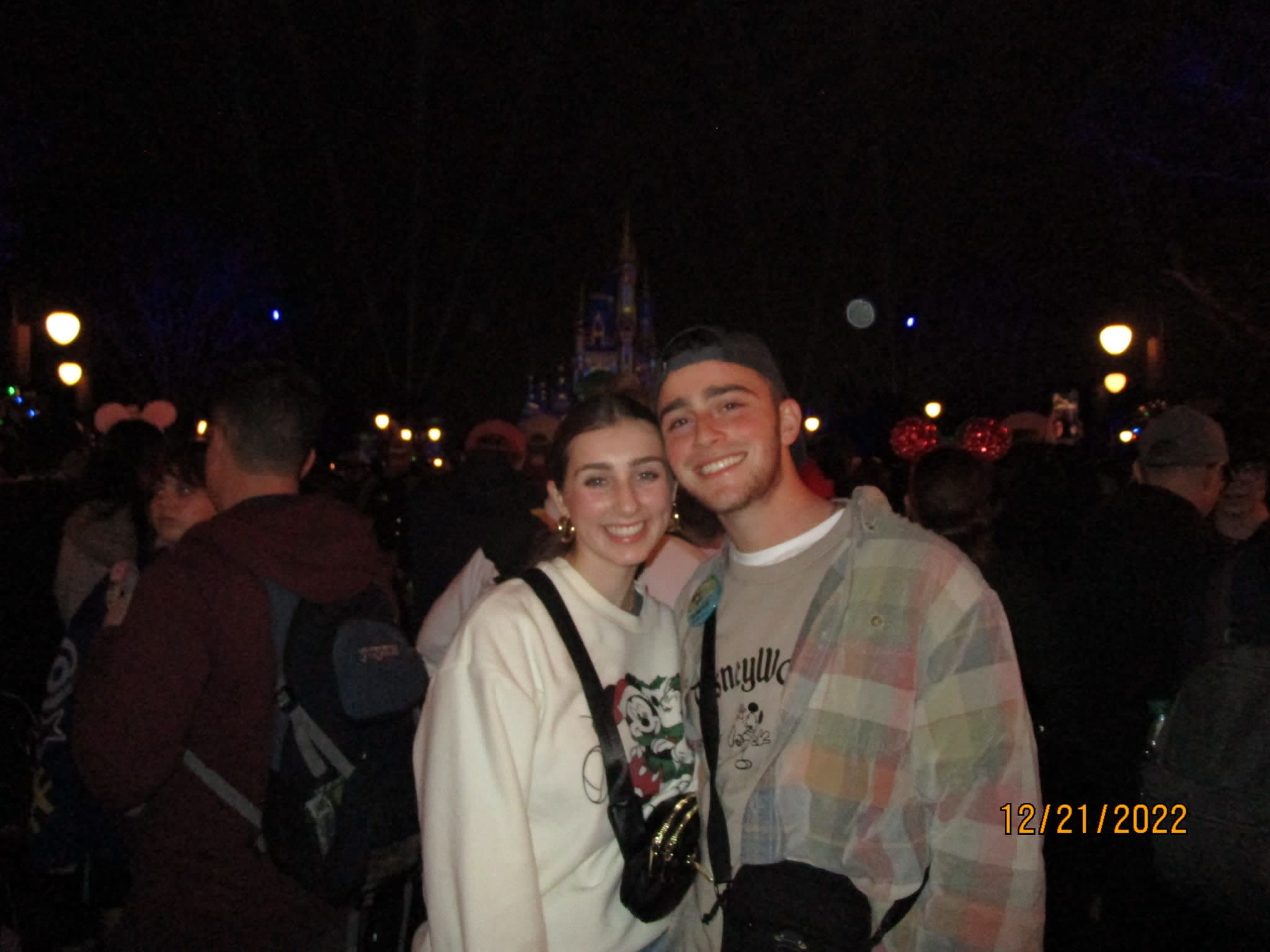 Couple smiling in a crowd at night