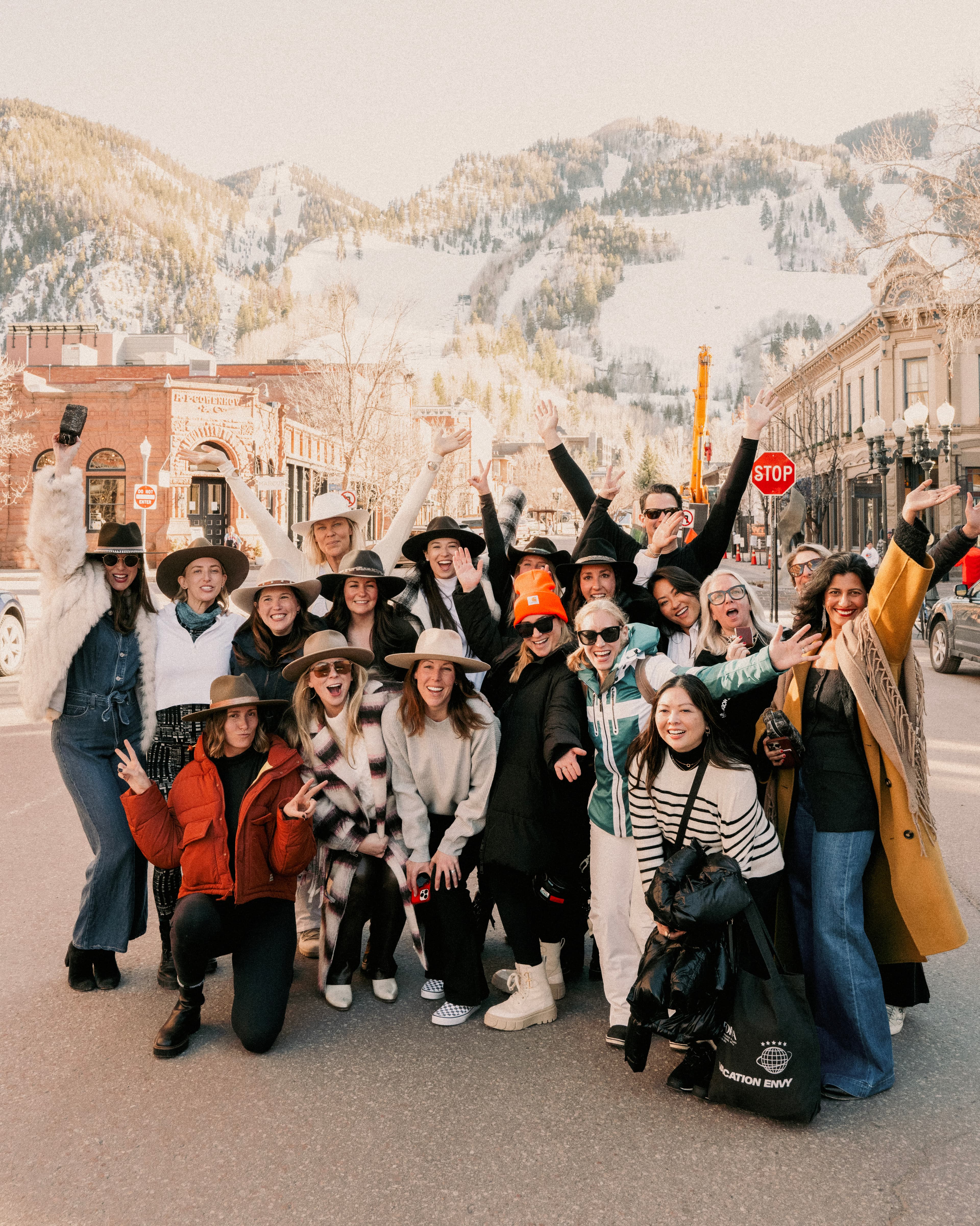 people walk on a boardwalk flanked by palm trees